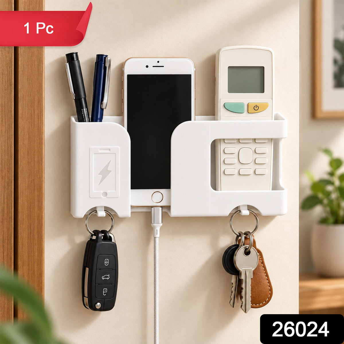 White wall-mounted organizer with smartphone, pens, remote, and keys, featuring a red '1 Pc' banner and a '26024' label at