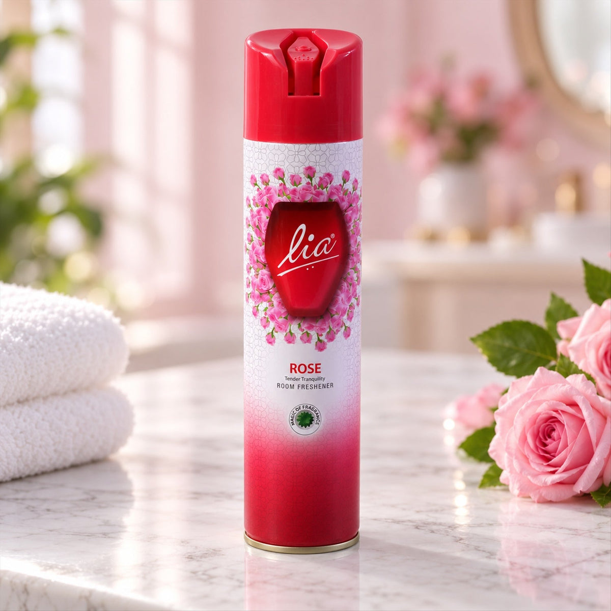 Red and white aerosol can with pink rose design, standing on a marble surface next to white towels and pink flowers.