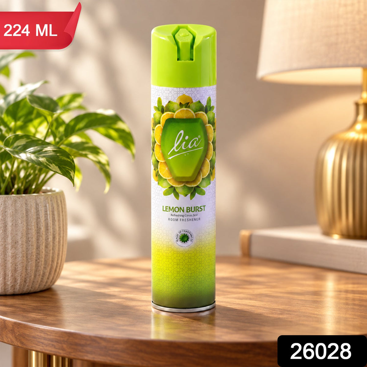 A Lia Lemon Burst room freshener spray bottle sits on a table with a plant and lamp, displaying '224 ML' and '26028' labels.