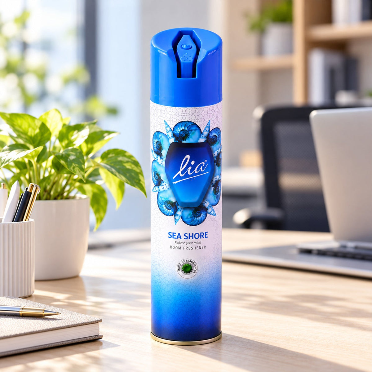 A blue and white aerosol spray can with a seashell design is placed on a wooden desk in an office setting.