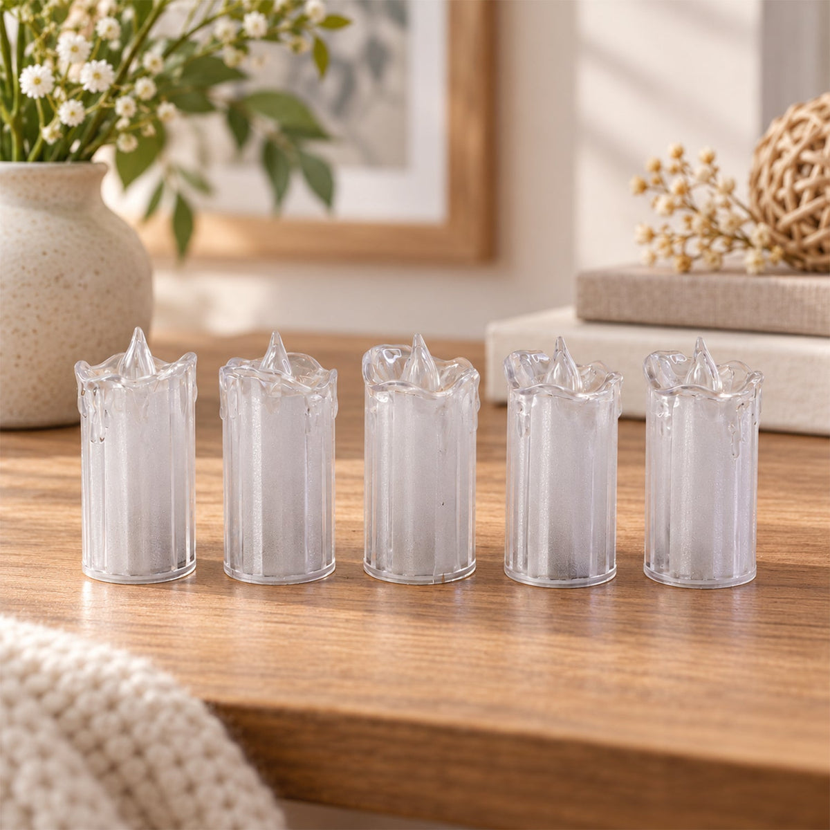 Flameless LED candles arranged on a table as festive home decor