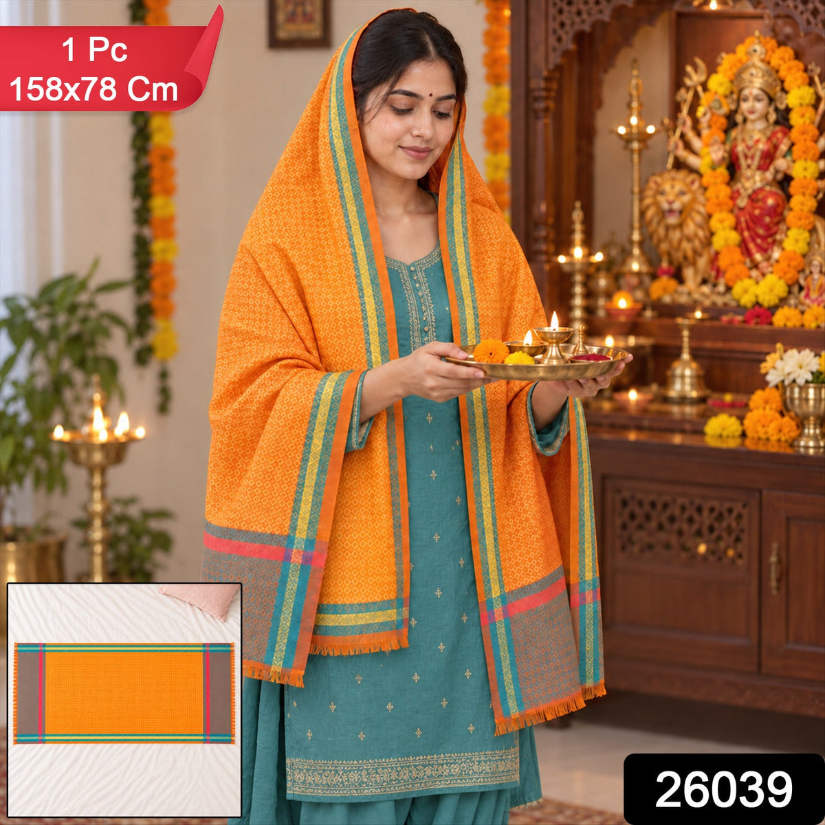 A woman in a teal dress holds a tray of lit diyas, wearing an orange shawl with striped borders.