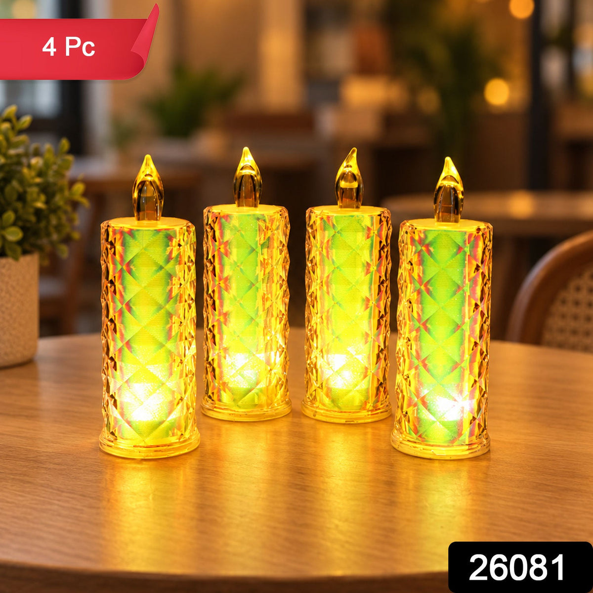 Four glowing crystal LED candles are arranged on a wooden surface, with a small green plant in a pot to the left.