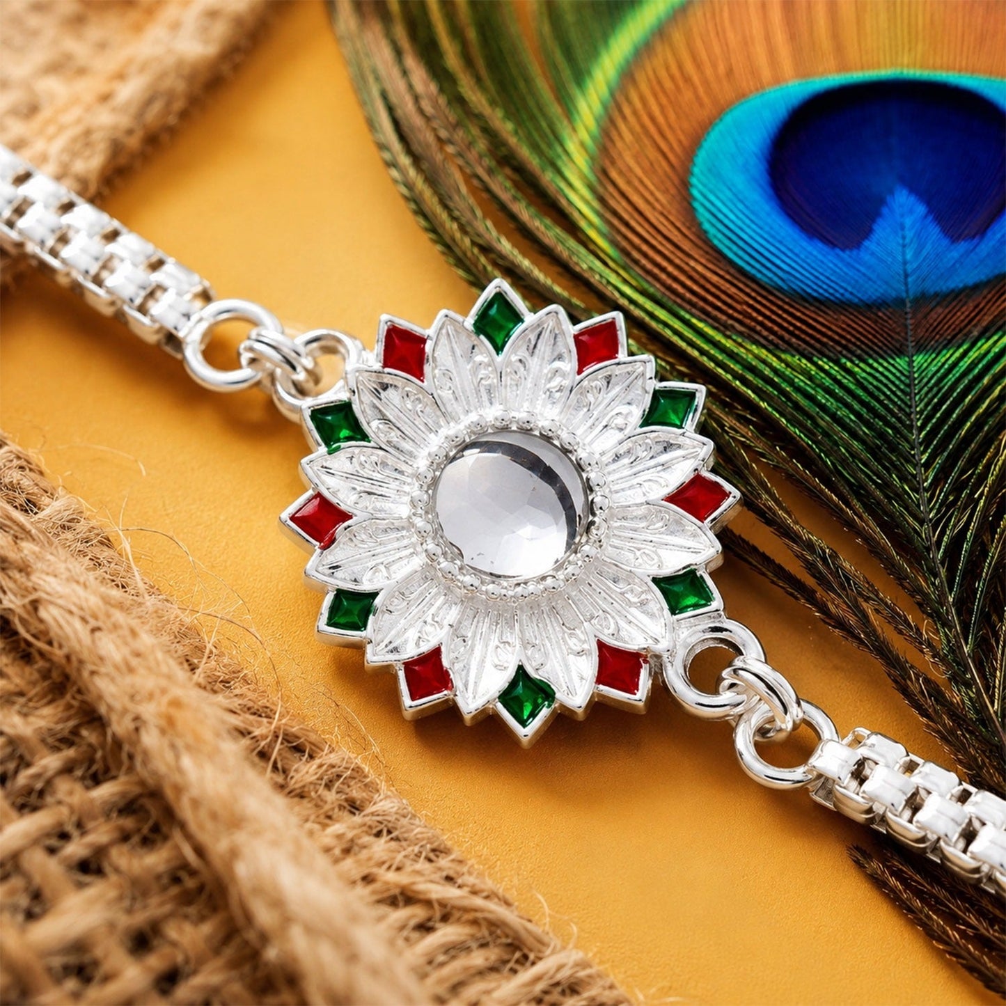 Elegant Silver Rakhi for brother, featuring floral Meenakari accents and red thread.