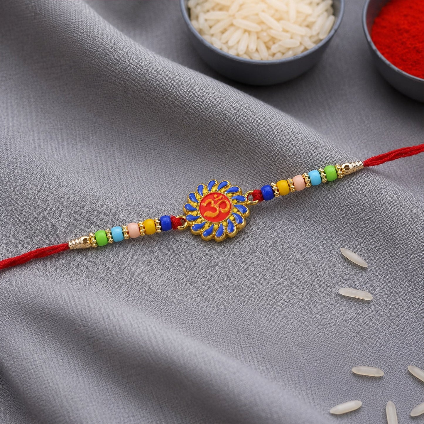 Om Rakhi with colorful beads displayed on white background.