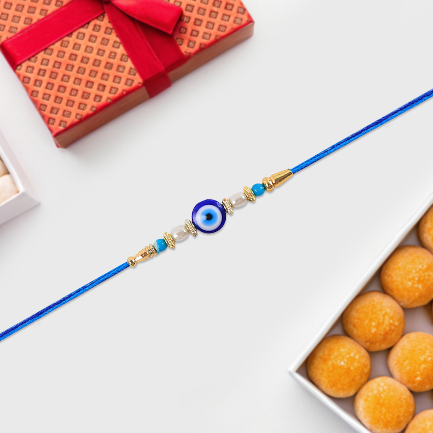 Detailed view of Blue Rakhi highlighting its central stone and golden design