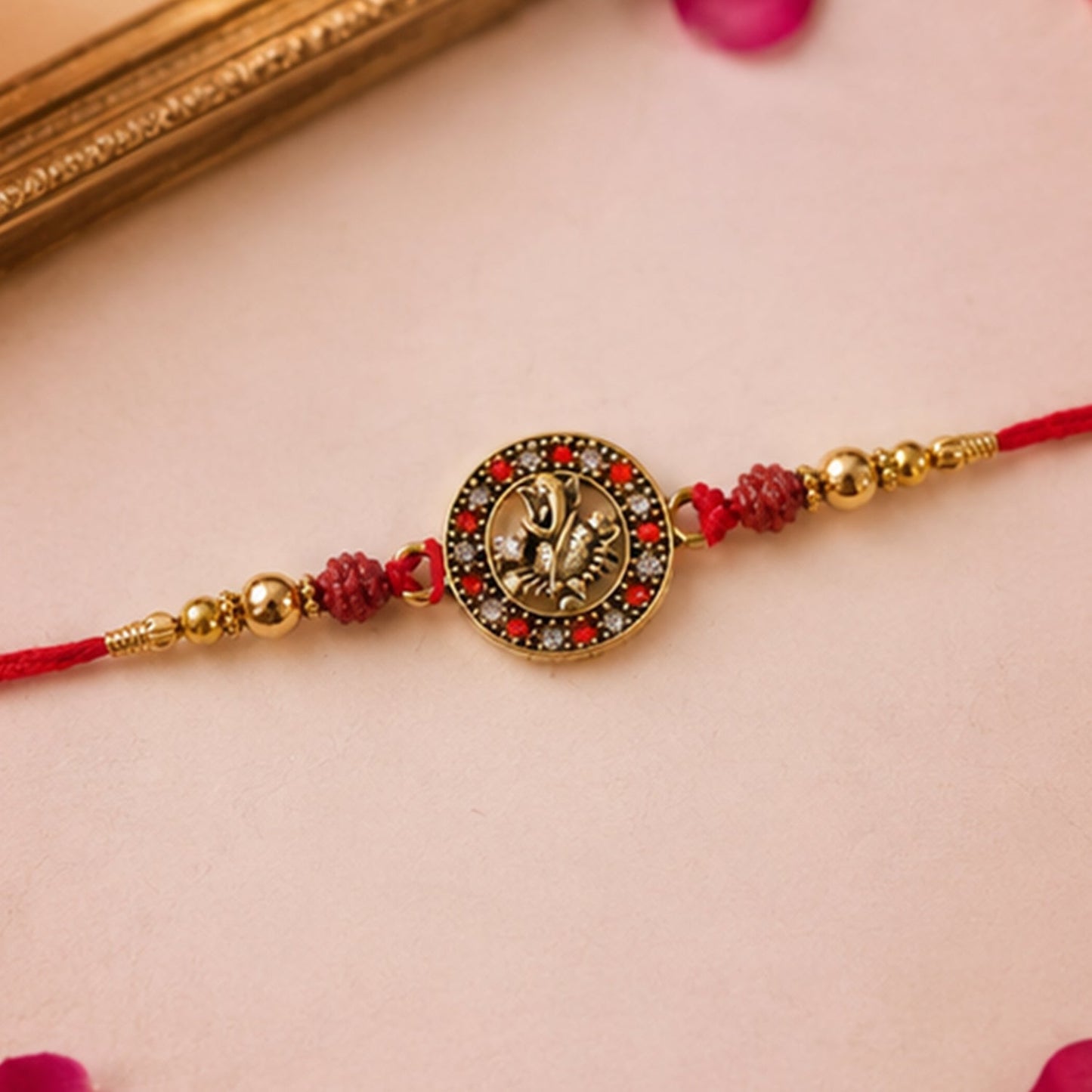 Close-up of Rudraksha beads on Golden Ganesh Rakhi for brother