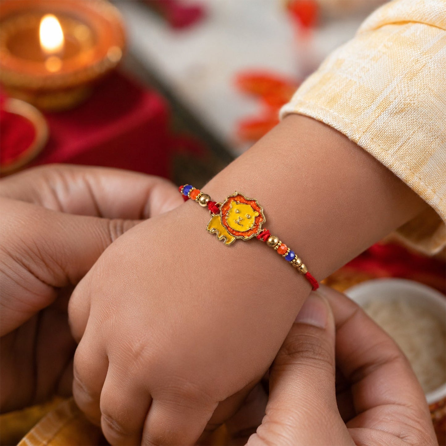 Close-up view of the cute lion face on the kids rakhi showing detailed craftsmanship.