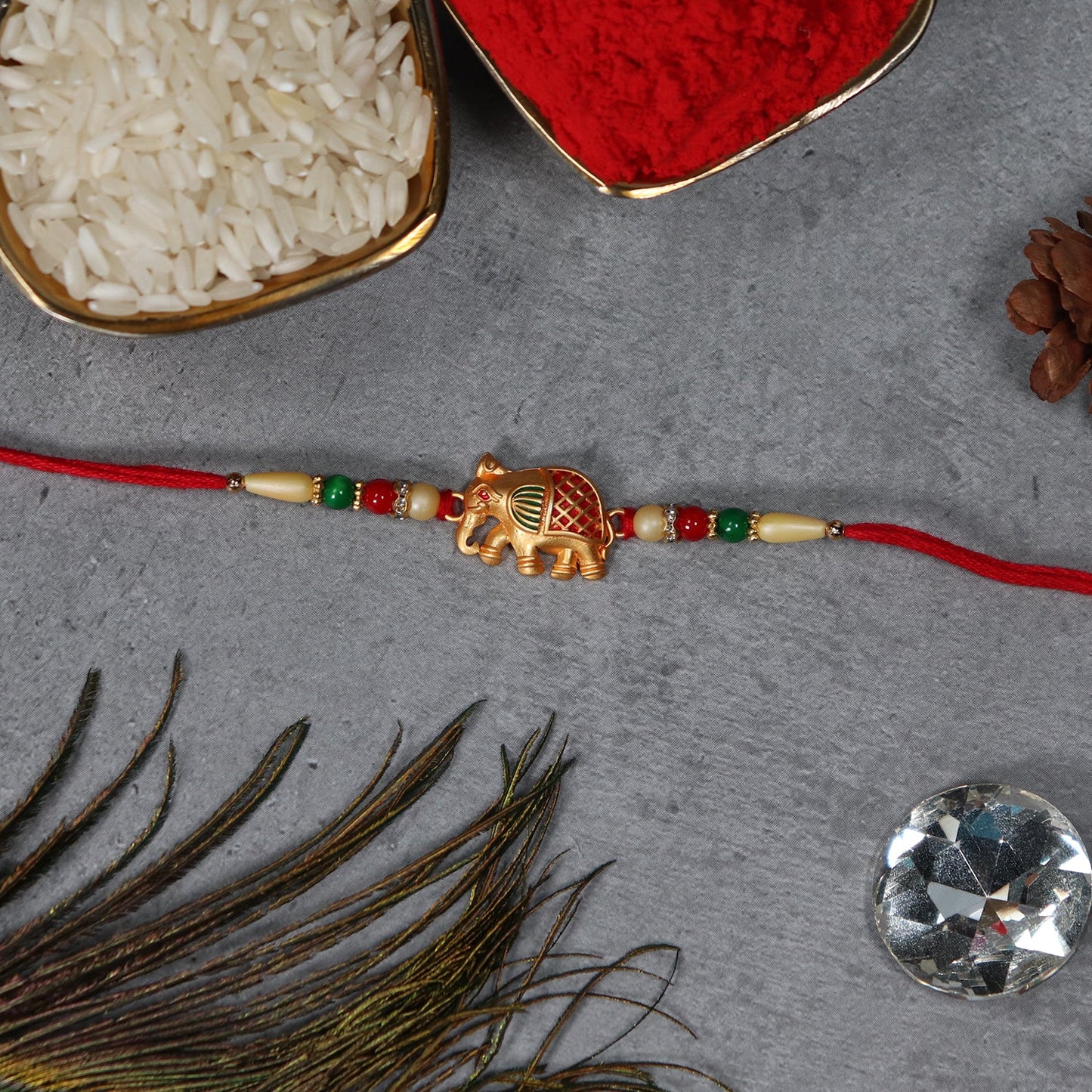 Thread work and elephant motif on traditional Raksha Bandhan Rakhi.