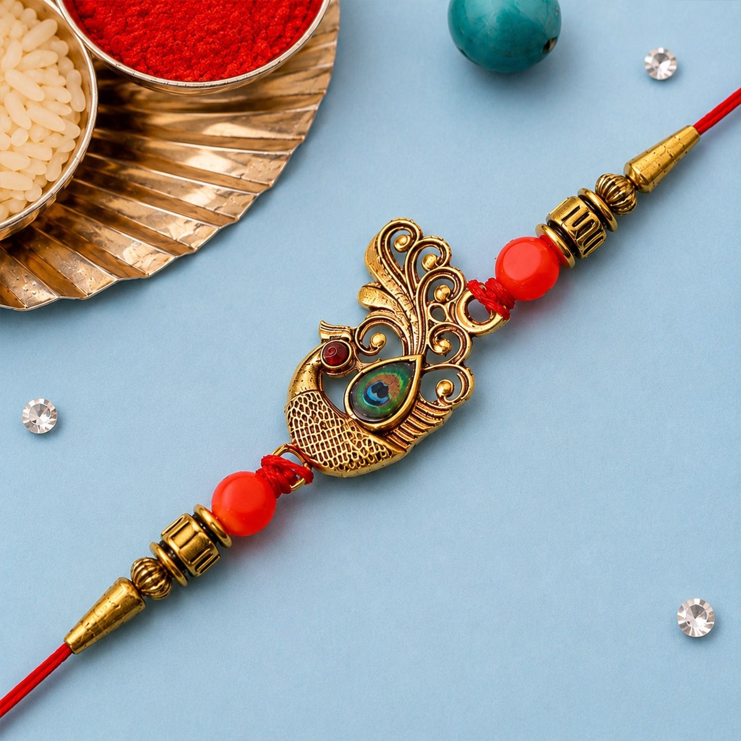 Close-up of an elegant Peacock Rakhi featuring golden beads and colorful stones