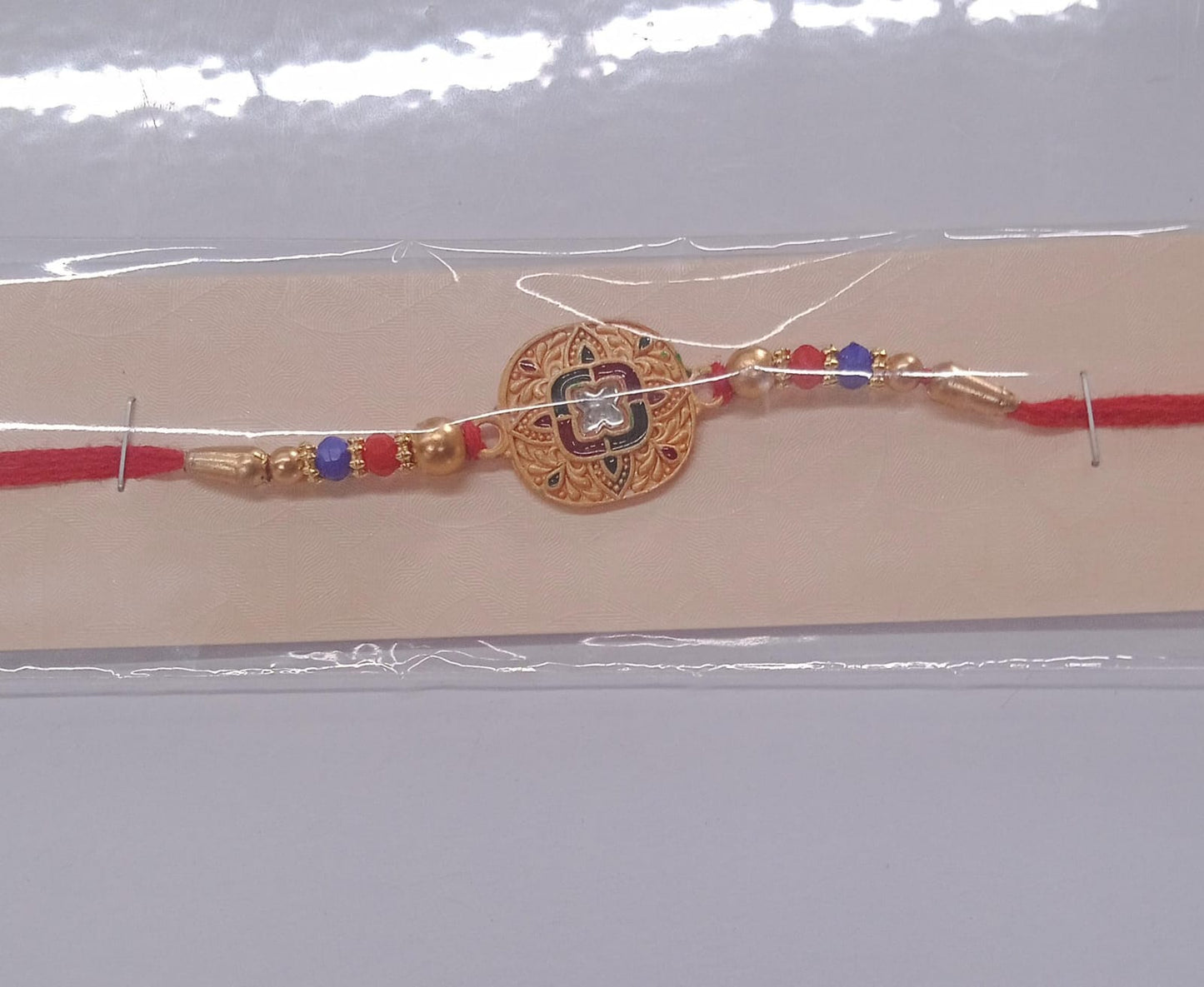 Close-up of handcrafted Kundan Rakhi featuring premium antique gold finish