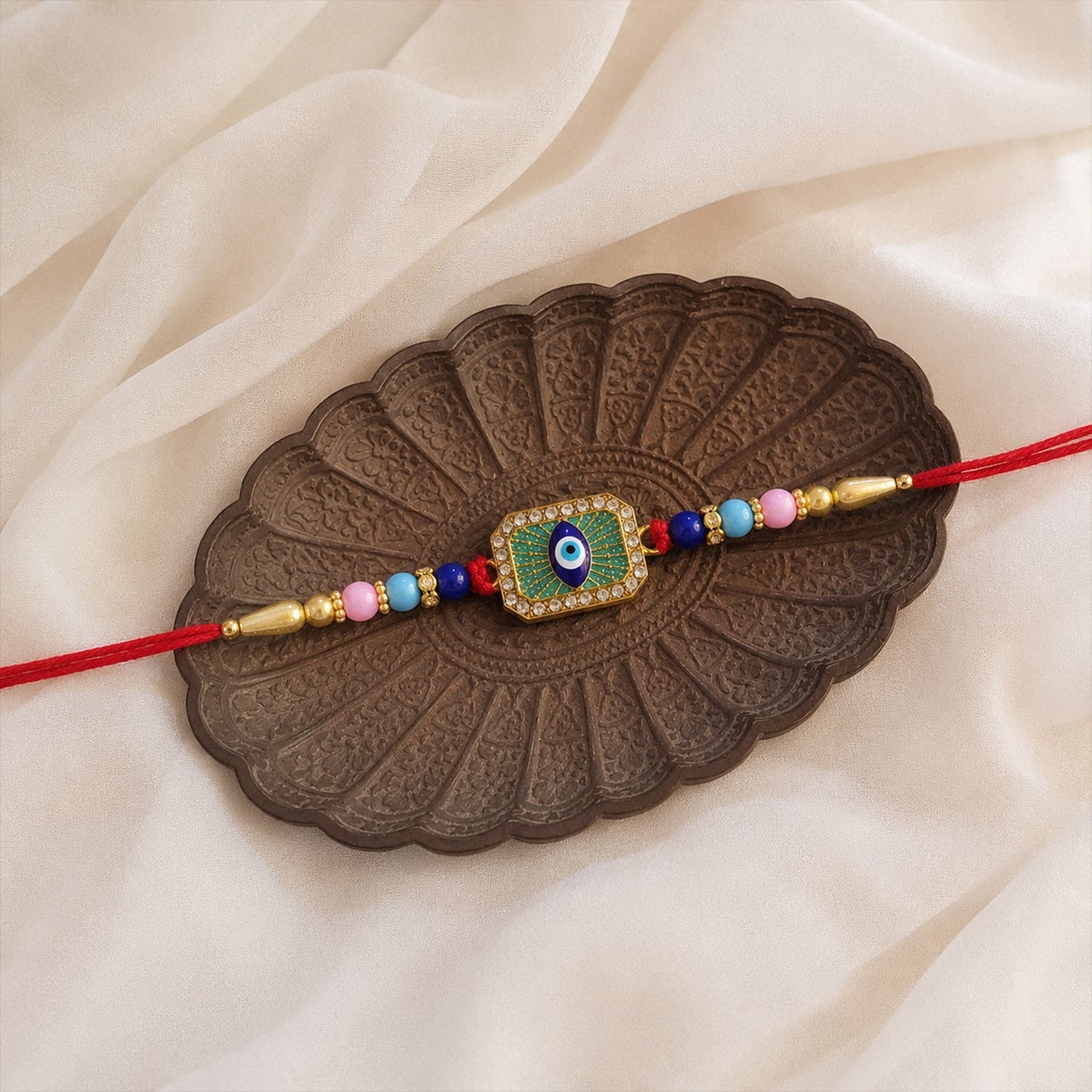 Stylish Evil Eye Rakhi with mint green thread and decorative evil eye centerpiece