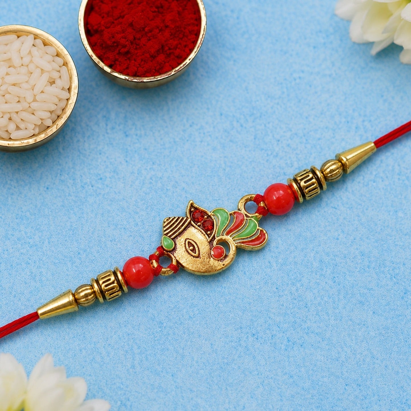 Elegant Ganpati Rakhi with traditional design symbolizing blessings for brother.