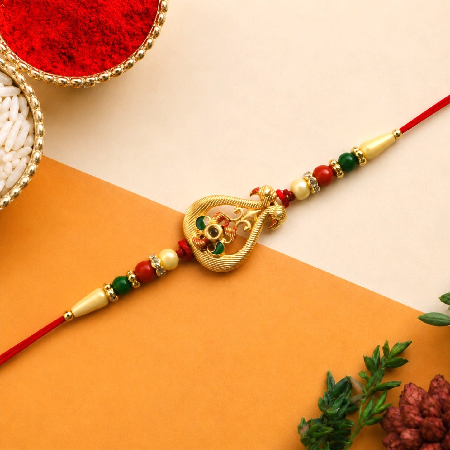 Elegant designer Rakhi for brother featuring colorful stones and beads on premium thread.