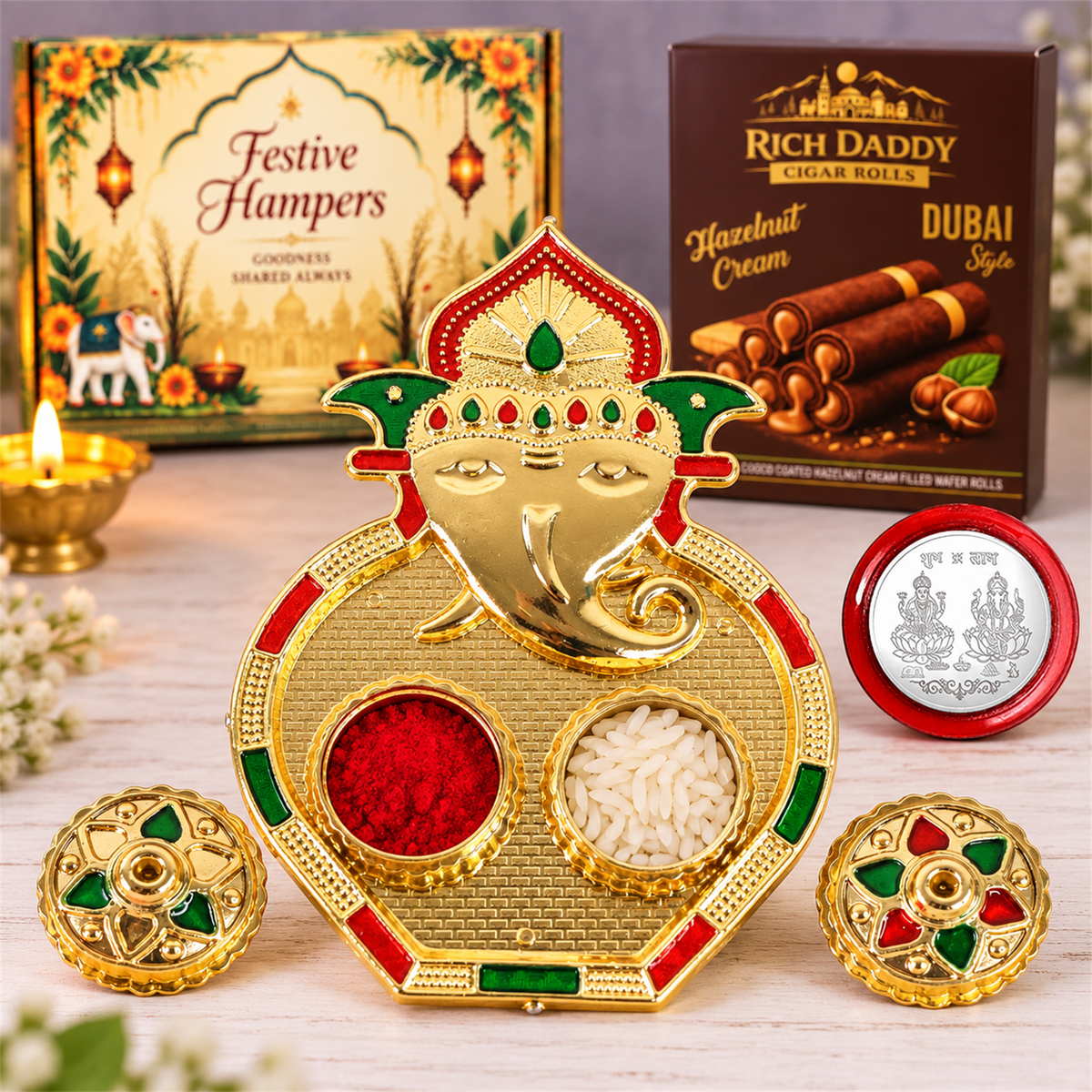 A gold Ganesh kumkum dish filled with red kumkum and white rice, with its decorative lids beside it, a silver coin, and a