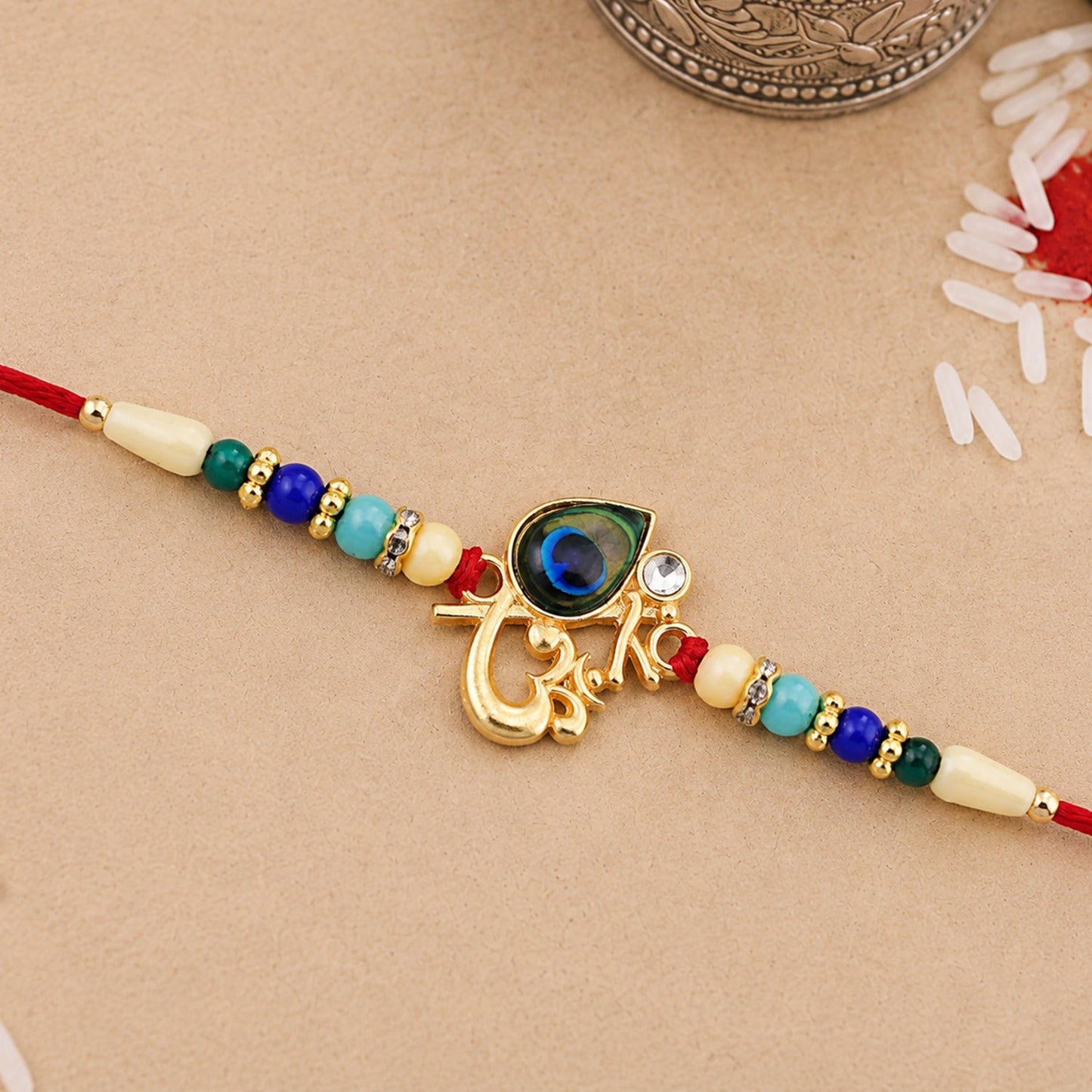 Detailed Peacock Feather Rakhi with vibrant multicolor beads and golden accents
