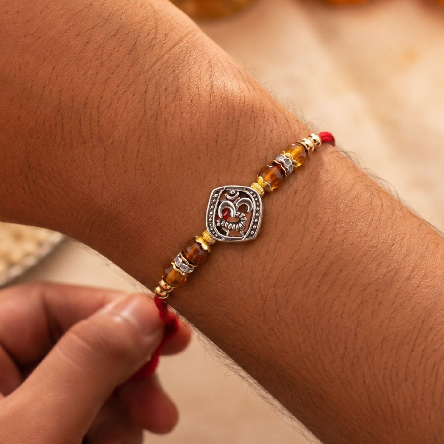 Elegant Om Rakhi displayed on a festive background, perfect for a brother.