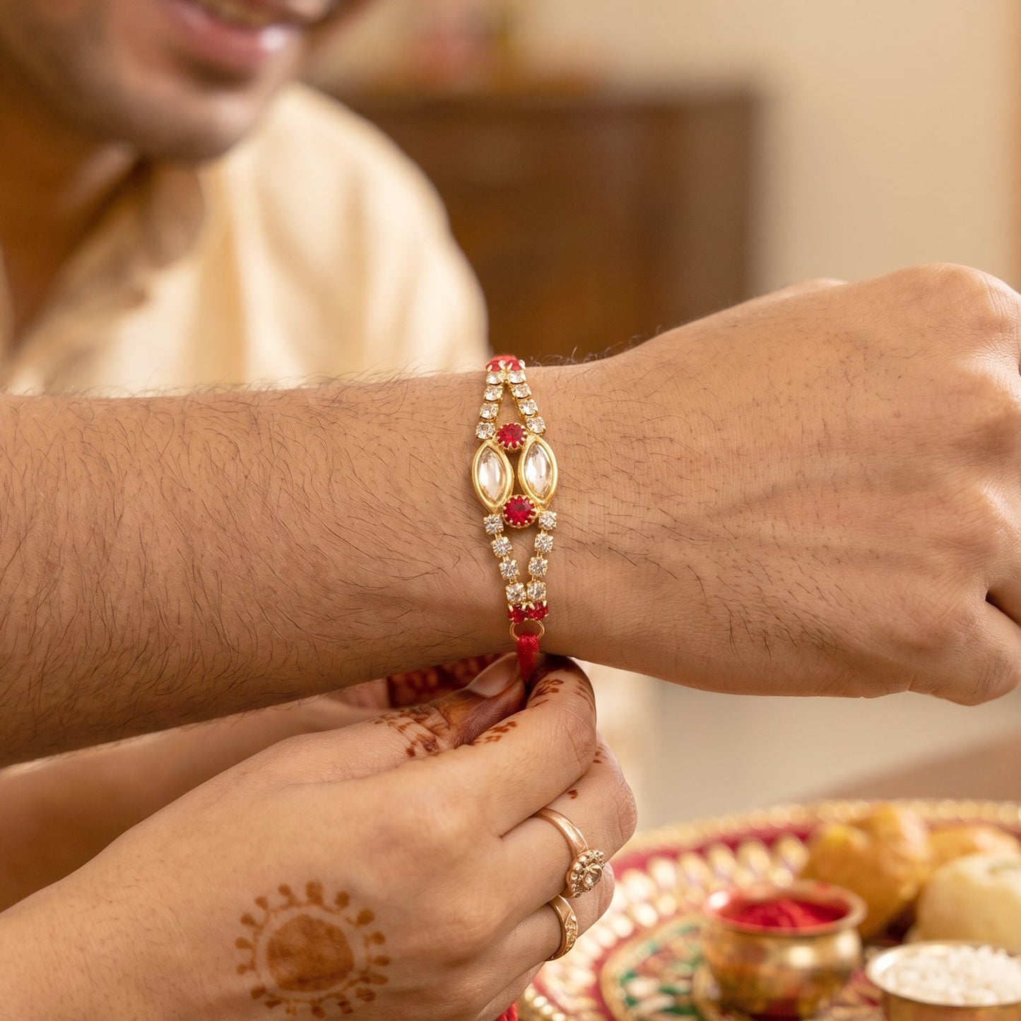 Wrist shot of the Kundan Rakhi Bracelet showing its festive look.