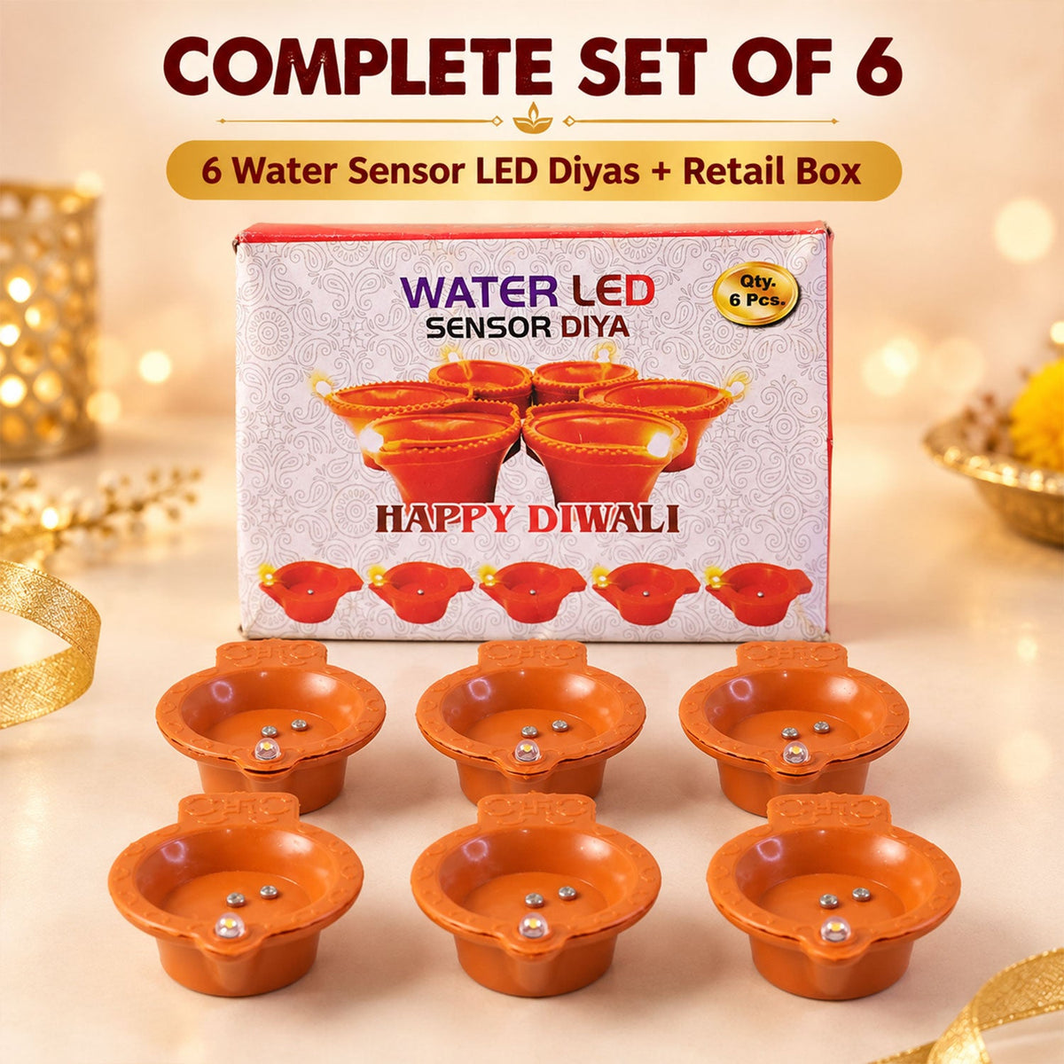 Six orange diyas are arranged in front of their retail box, which features the product name and a Diwali greeting.