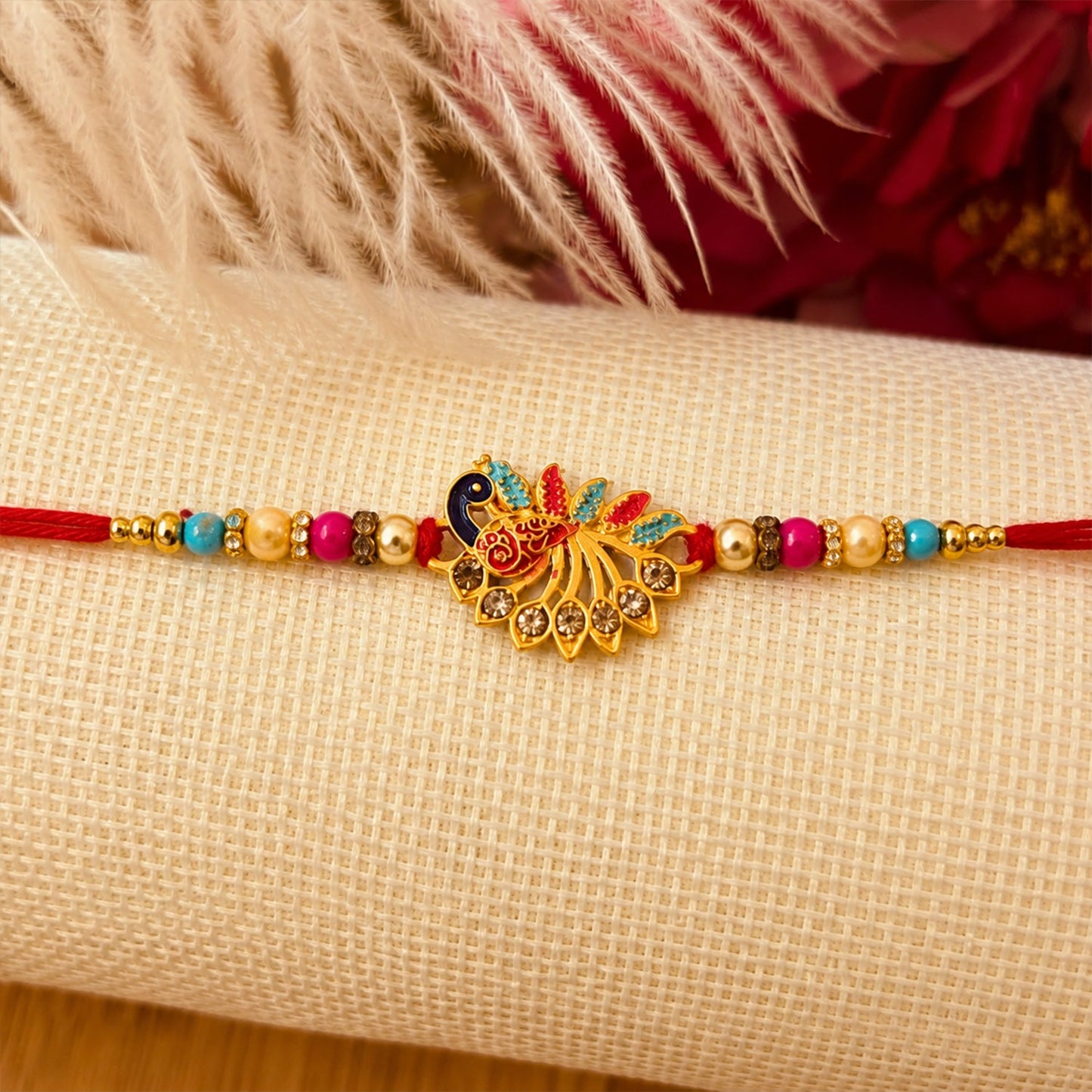 Colorful peacock Rakhi decorated with sparkling stones and beads