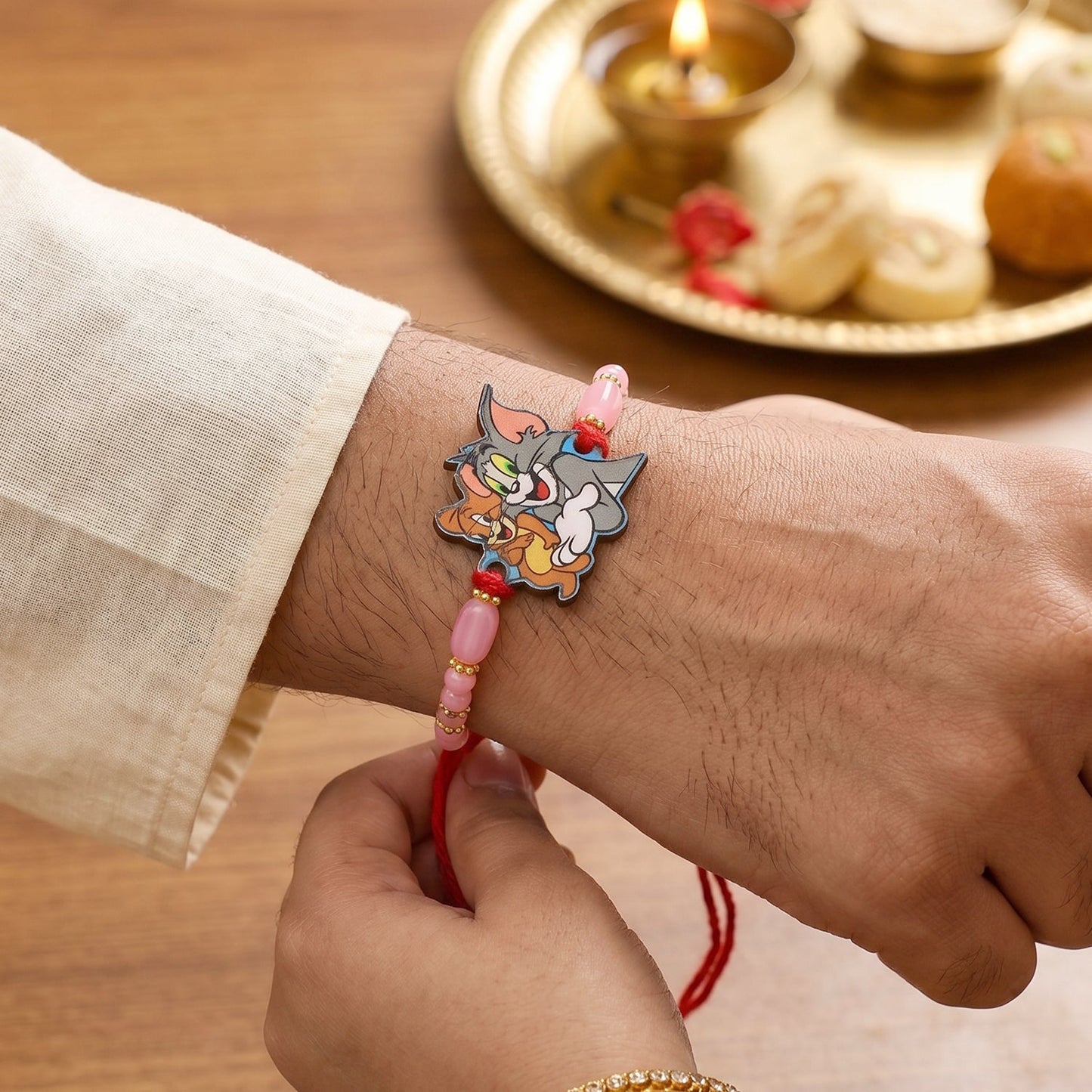 Lightweight cartoon design kids rakhi with gold accents