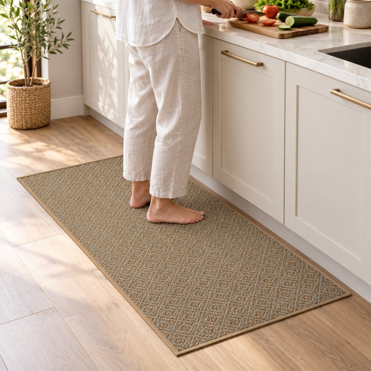 A person stands barefoot on a long, rectangular brown runner mat with a diamond pattern in a modern kitchen.