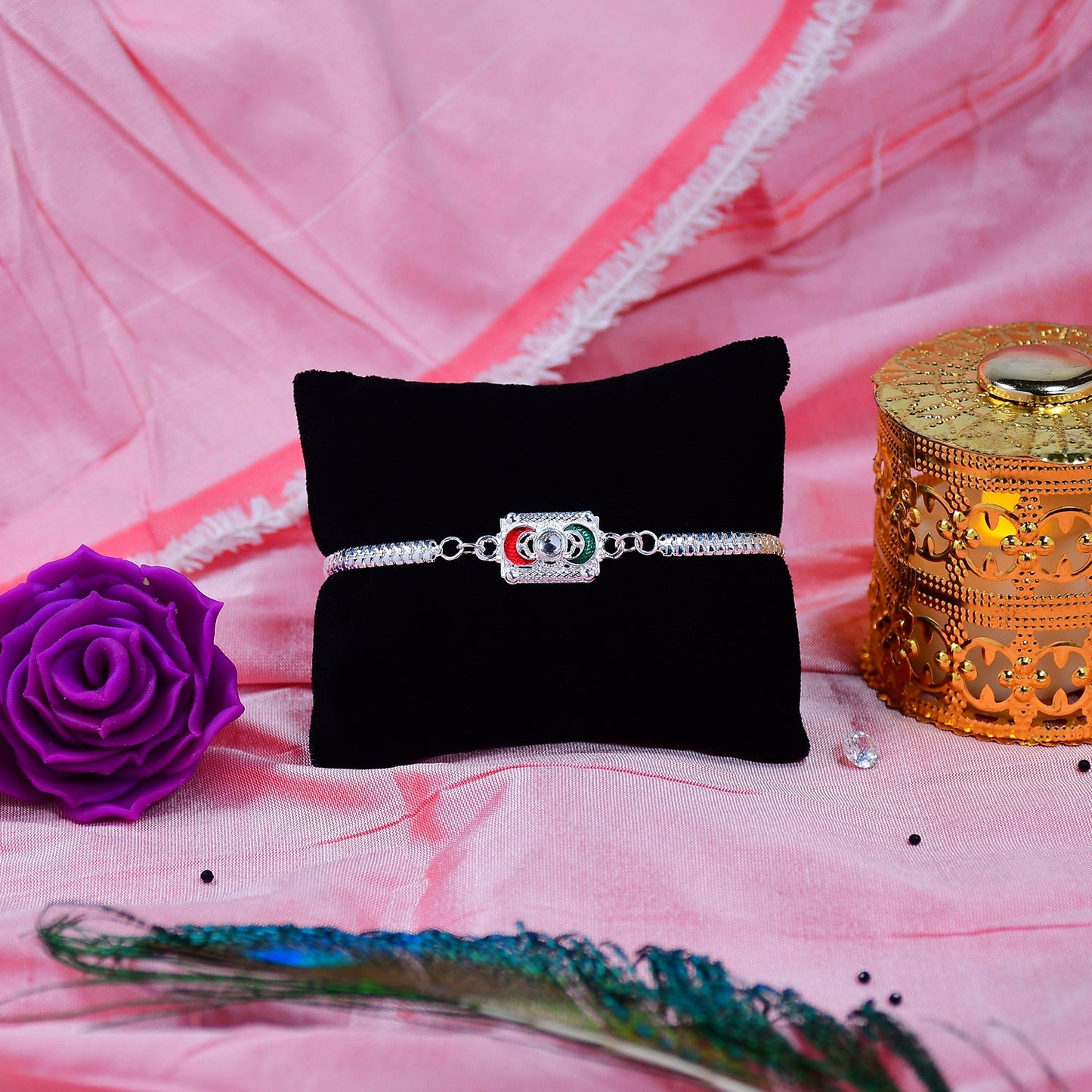 Close-up of geometric rakhi featuring linked rings and chain
