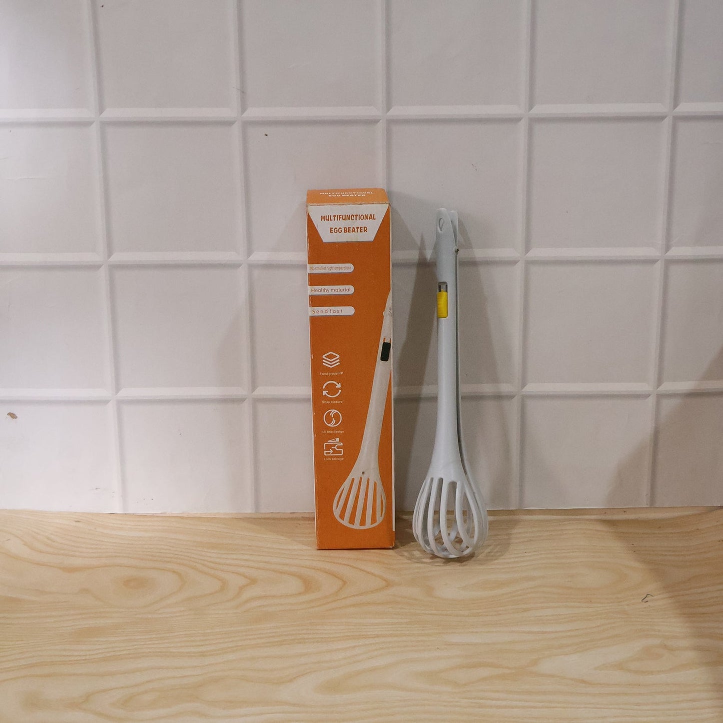 Egg beater with a long handle, ideal for baking, whisking, and serving noodles.