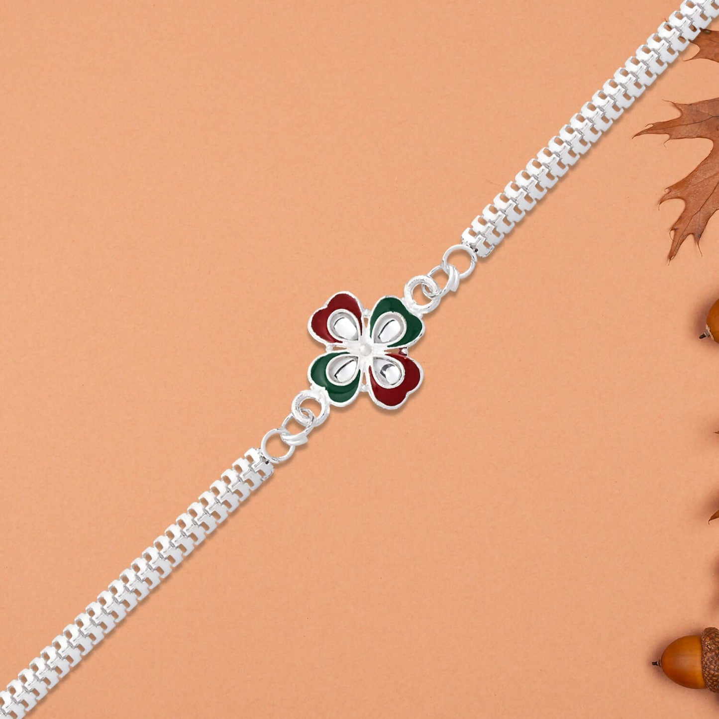 Vibrant tricolor enamel floral pattern detail on elegant Rakhi.