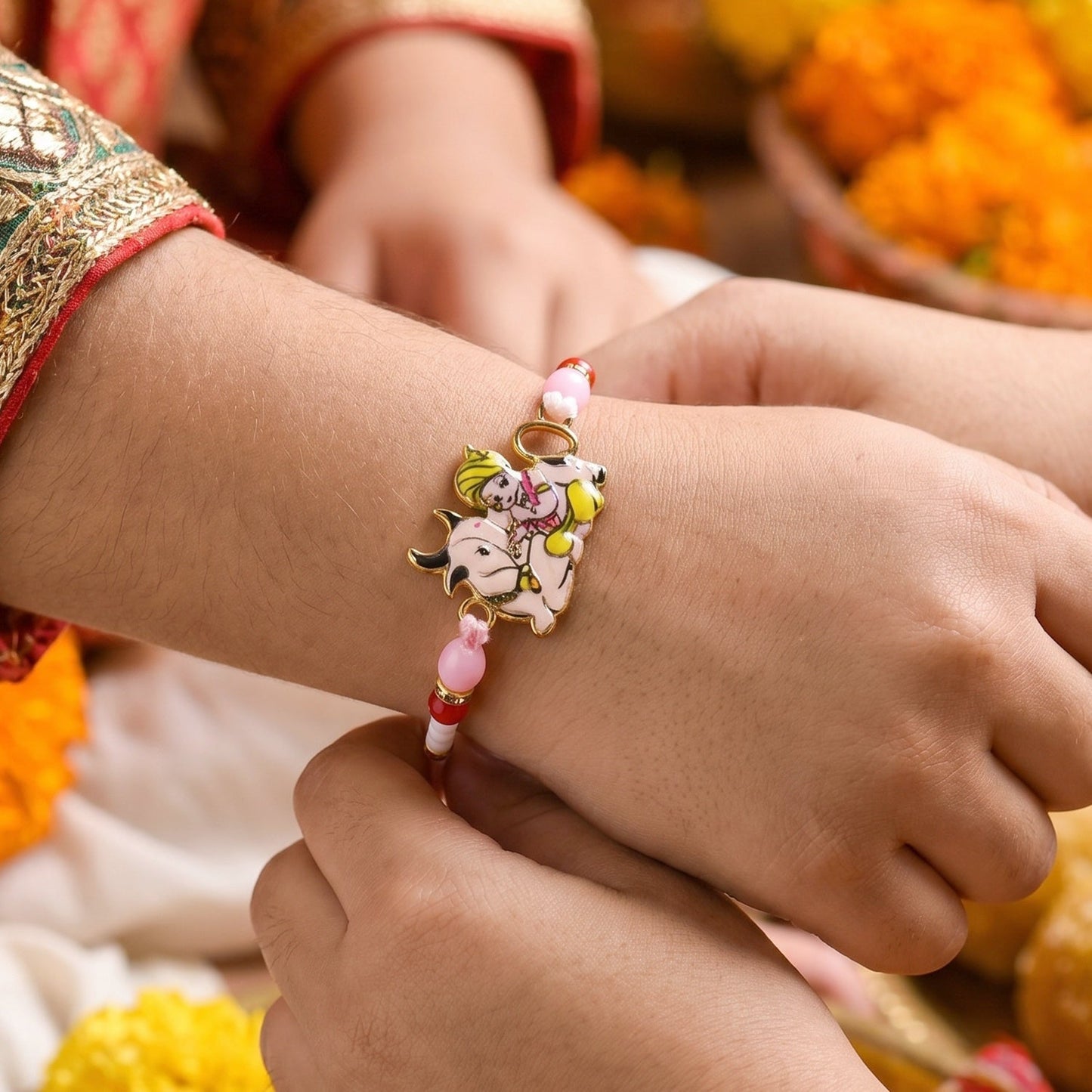 Decorative beads and traditional thread on Krishna Rakhi