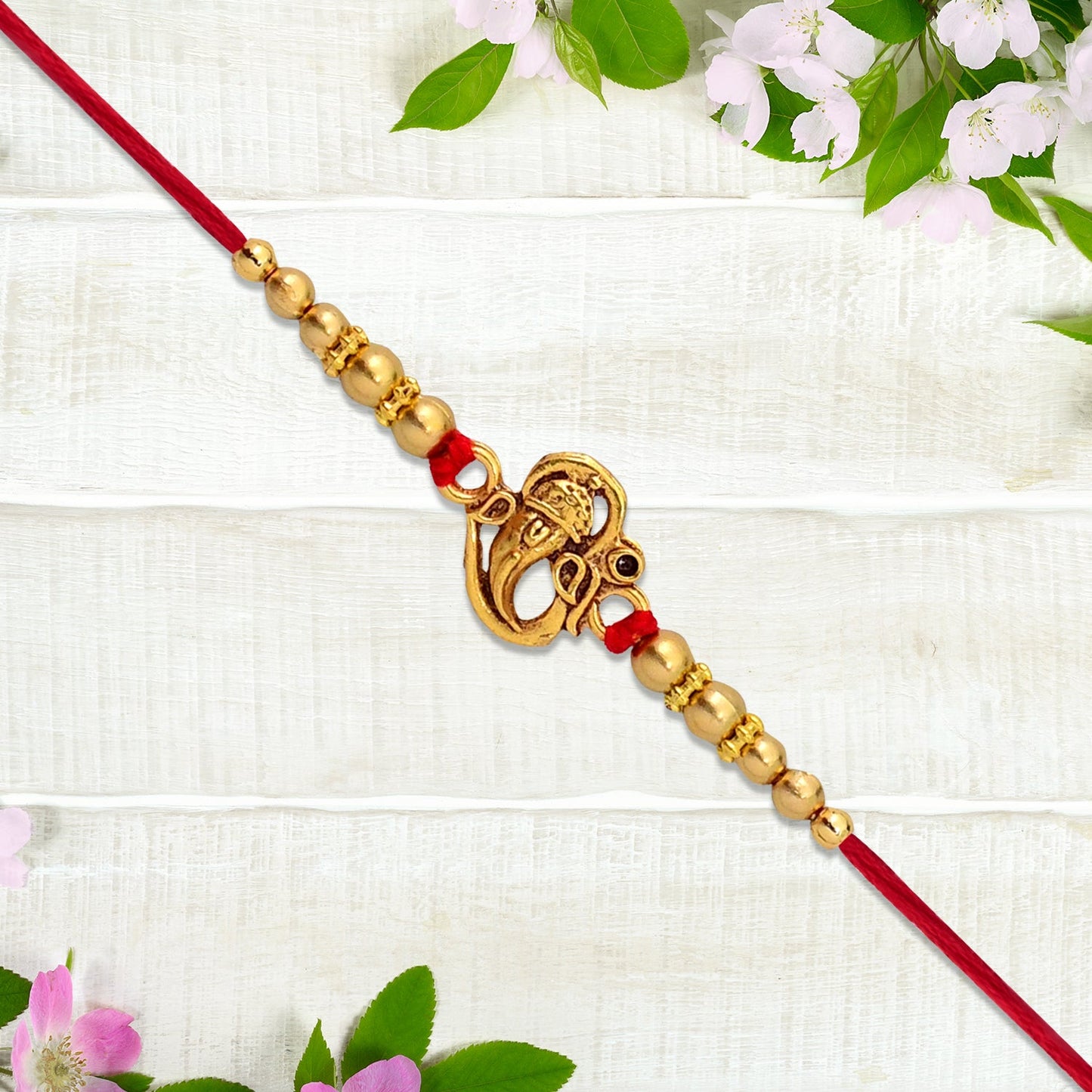 Vibrant red and gold Ganesha Rakhi embodying festive tradition.