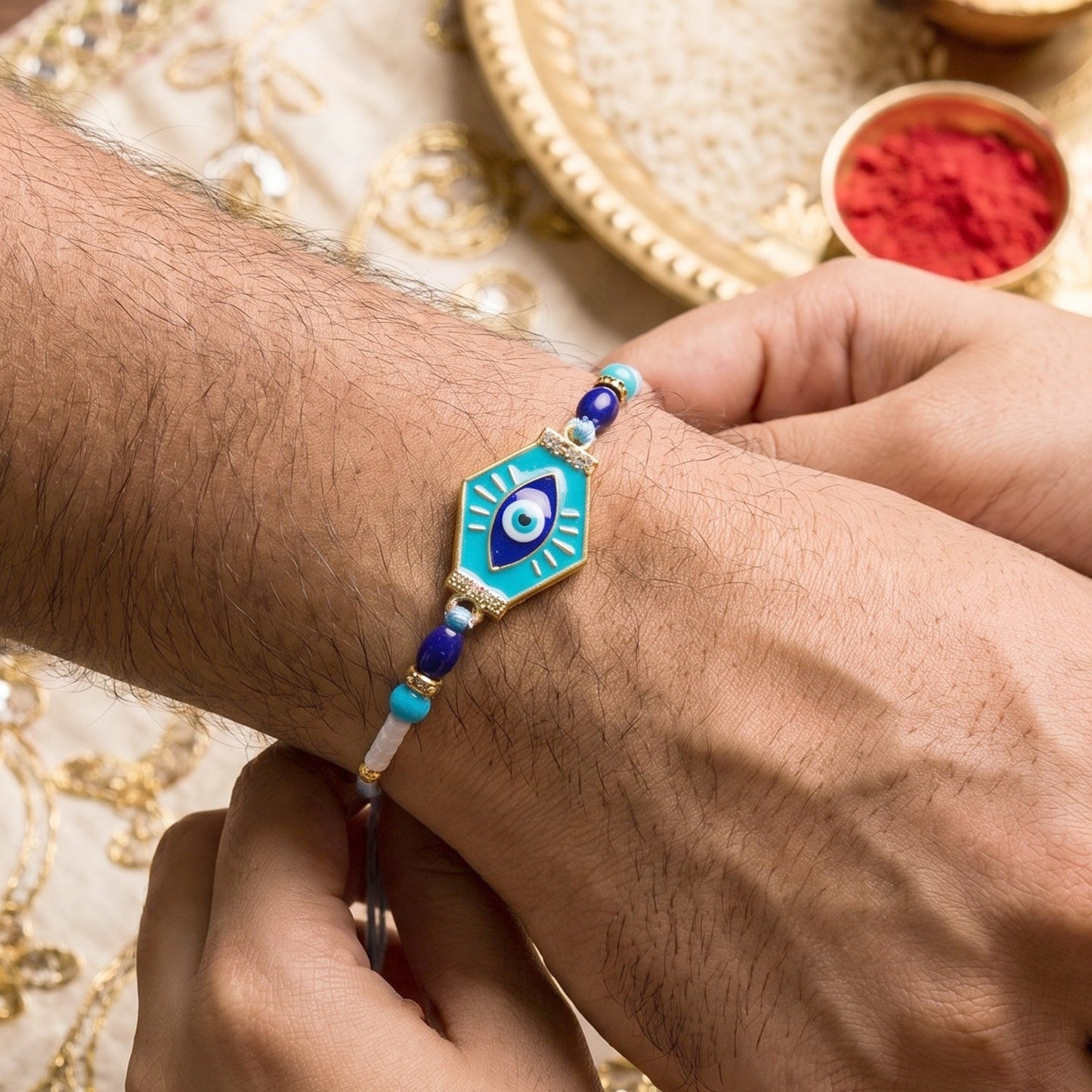 Modern turquoise hexagon Rakhi on soft thread