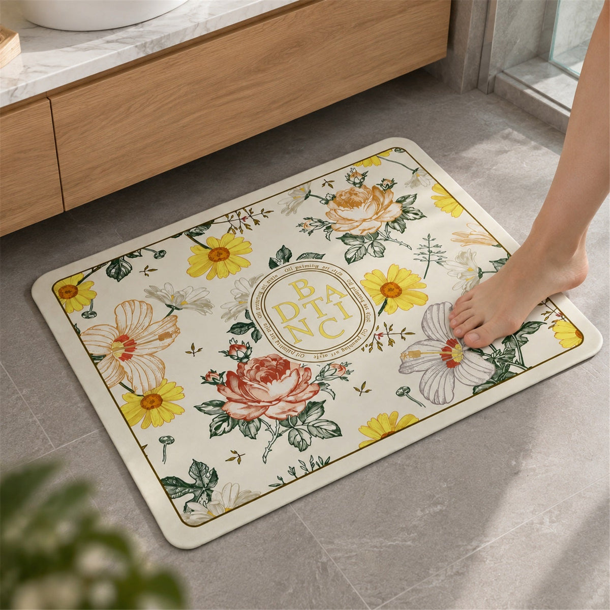 A single bare foot steps onto a rectangular bath mat with a vibrant floral pattern on a light background, placed on a grey