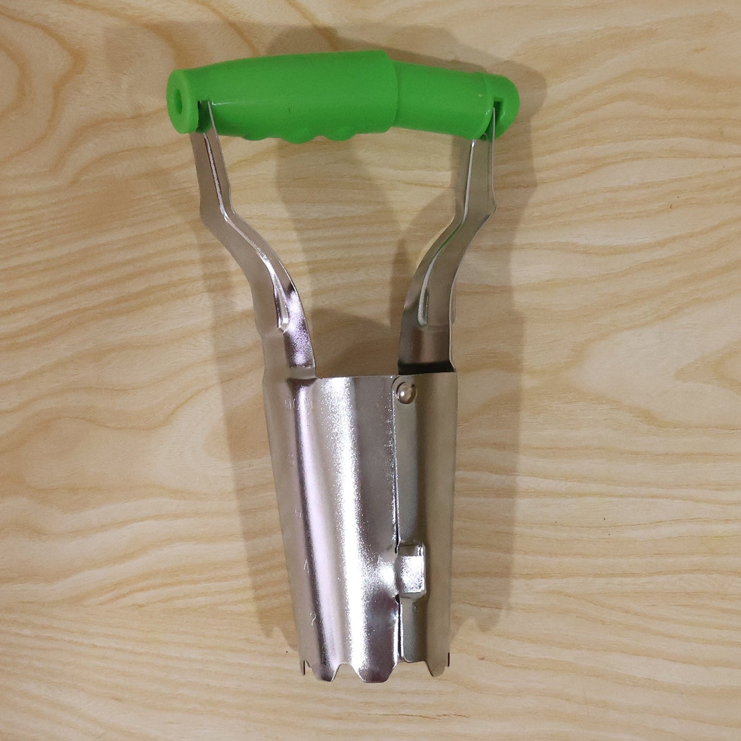 Garden tool used for planting bulbs in soil