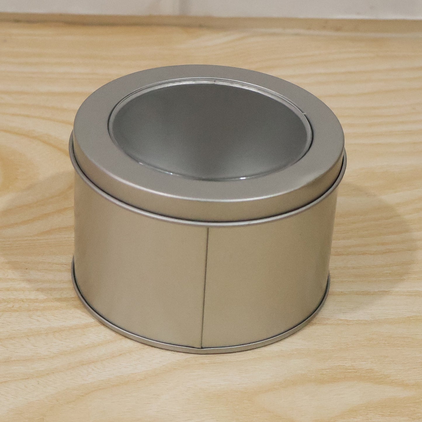 Premium finish round metal storage tin with transparent lid for gifting or organising.