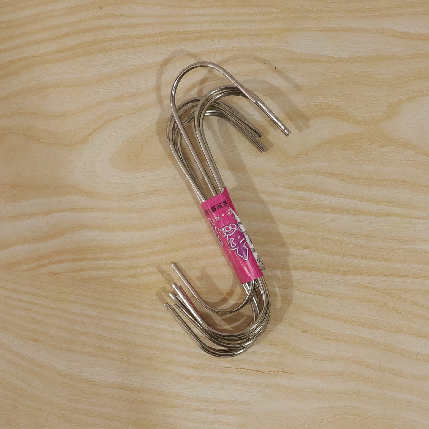 Versatile S hooks hanging from a rack, holding bags and supplies.
