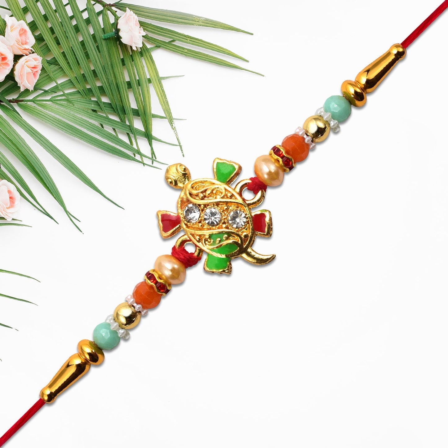 Side angle of tortoise design Rakhi with stones and beads