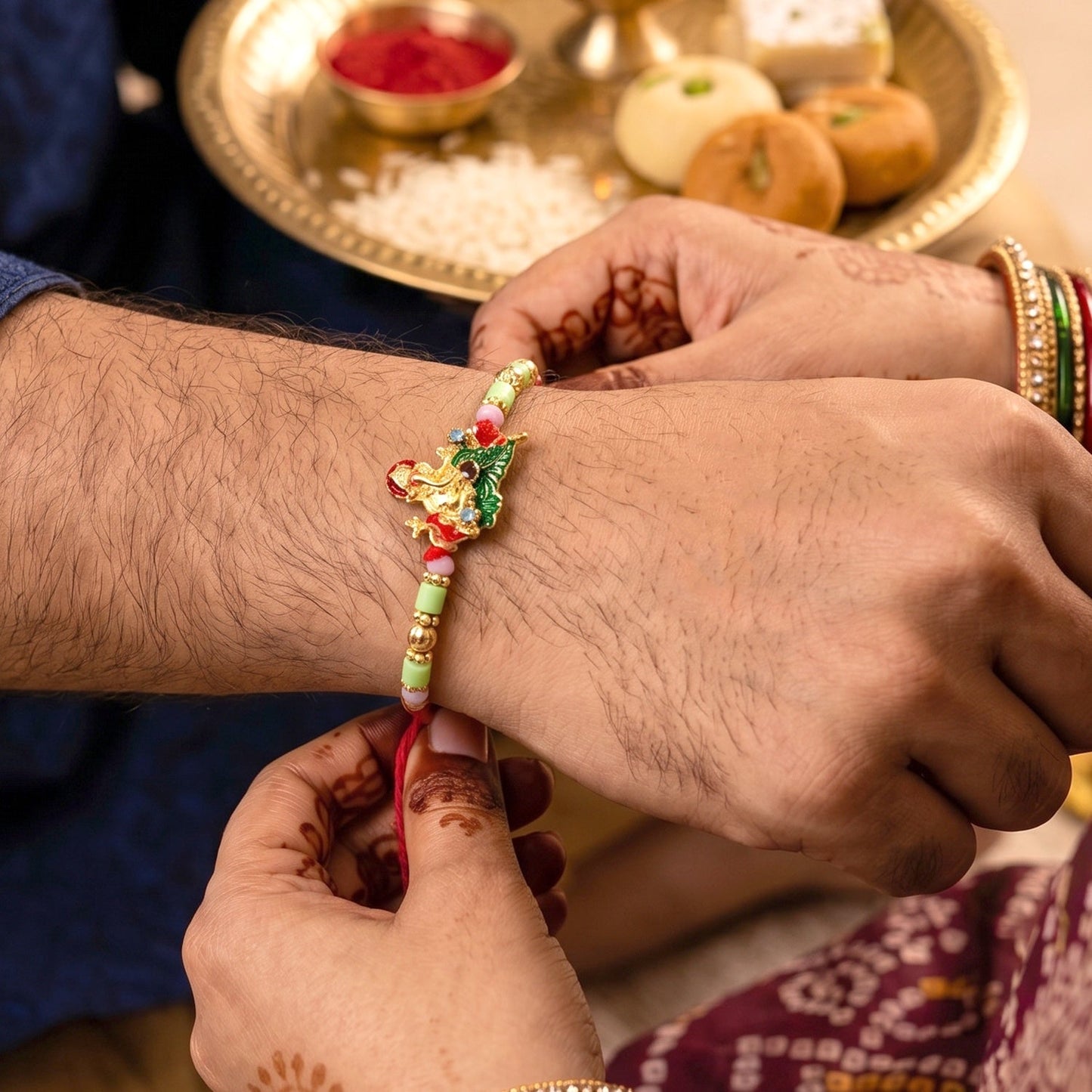 Close-up of decorative beads on Lord Ganesha Rakhi for a festive look