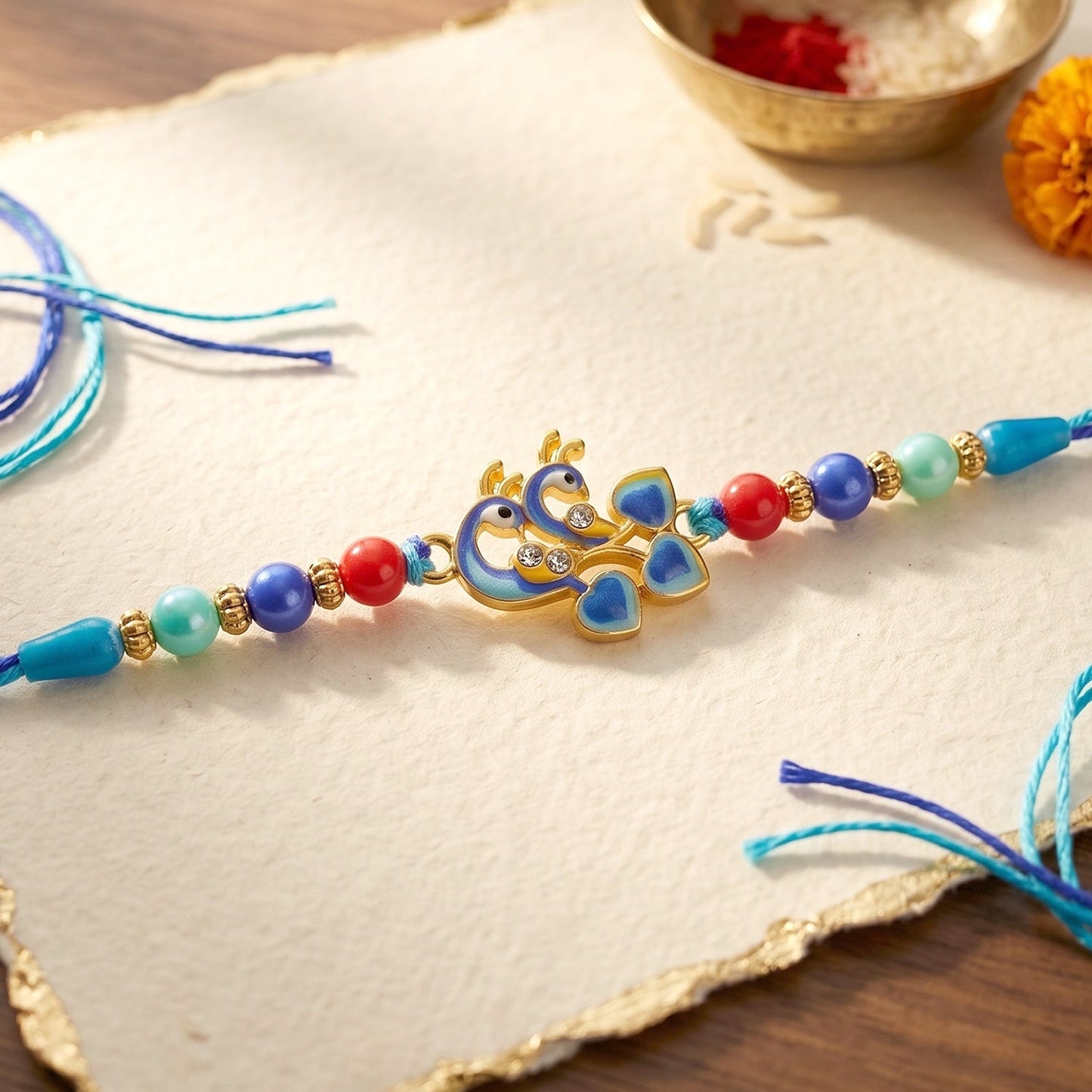 Front view of Twin Peacock Golden Enamel Designer Rakhi