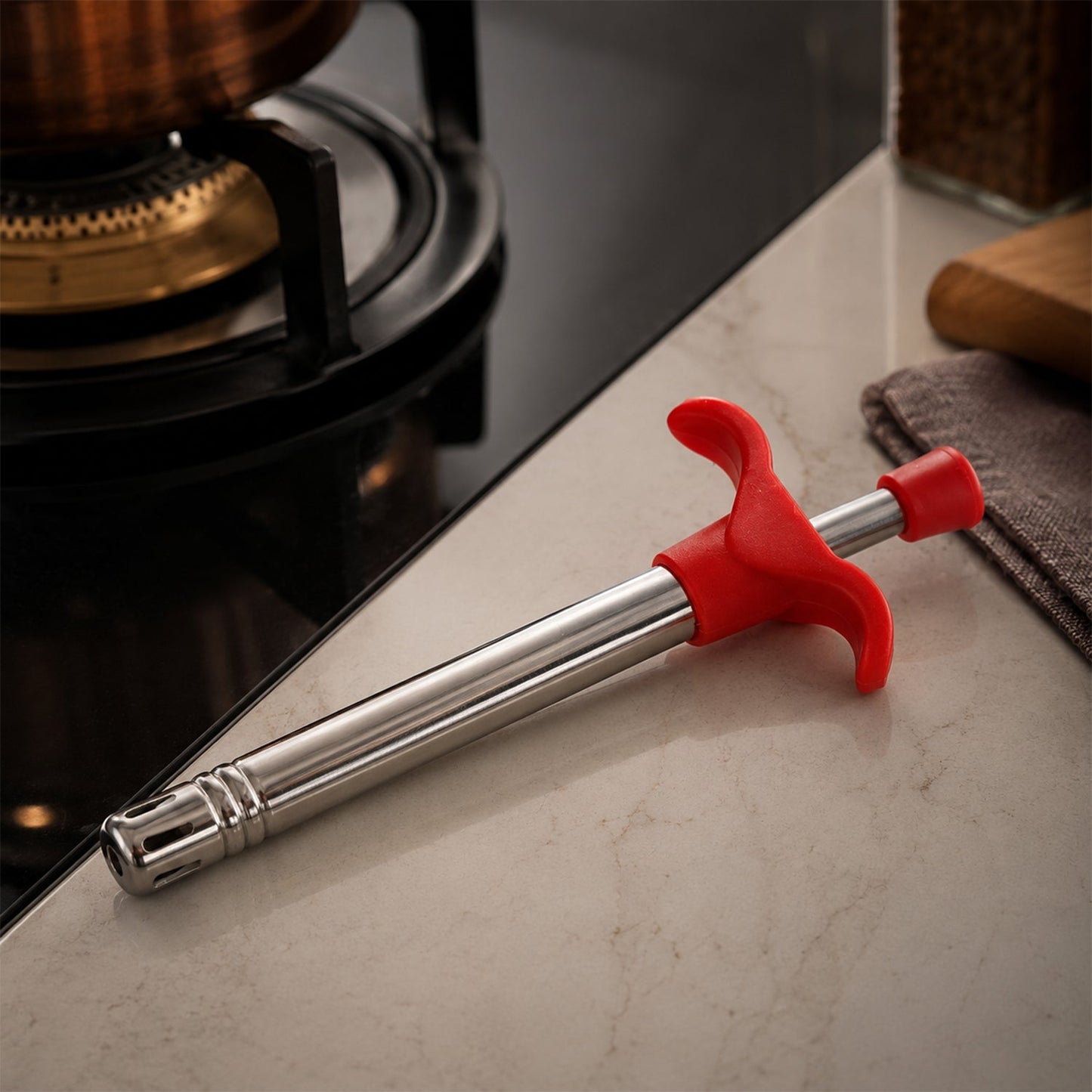 Gas lighter igniting a stove burner