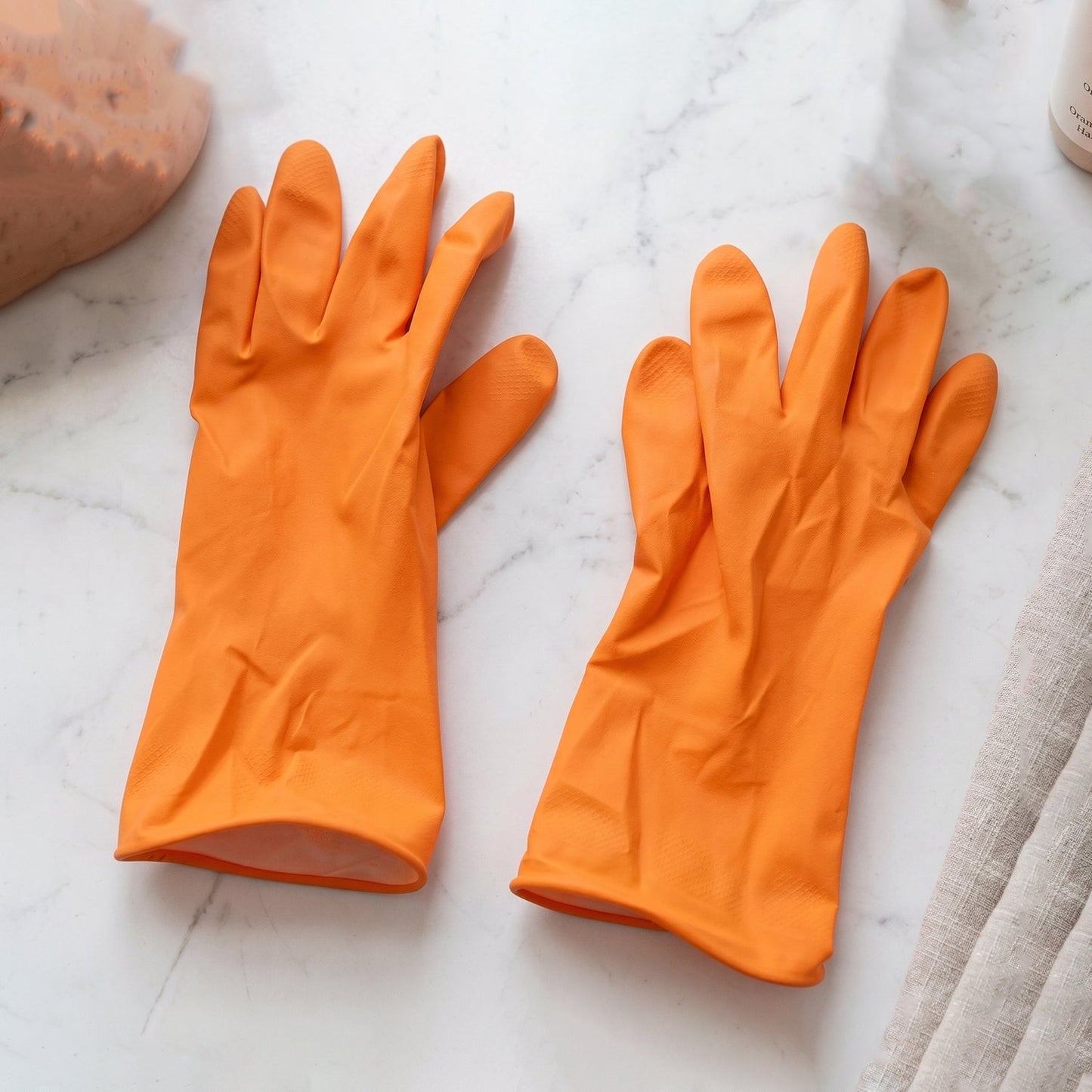 Reusable orange rubber gloves