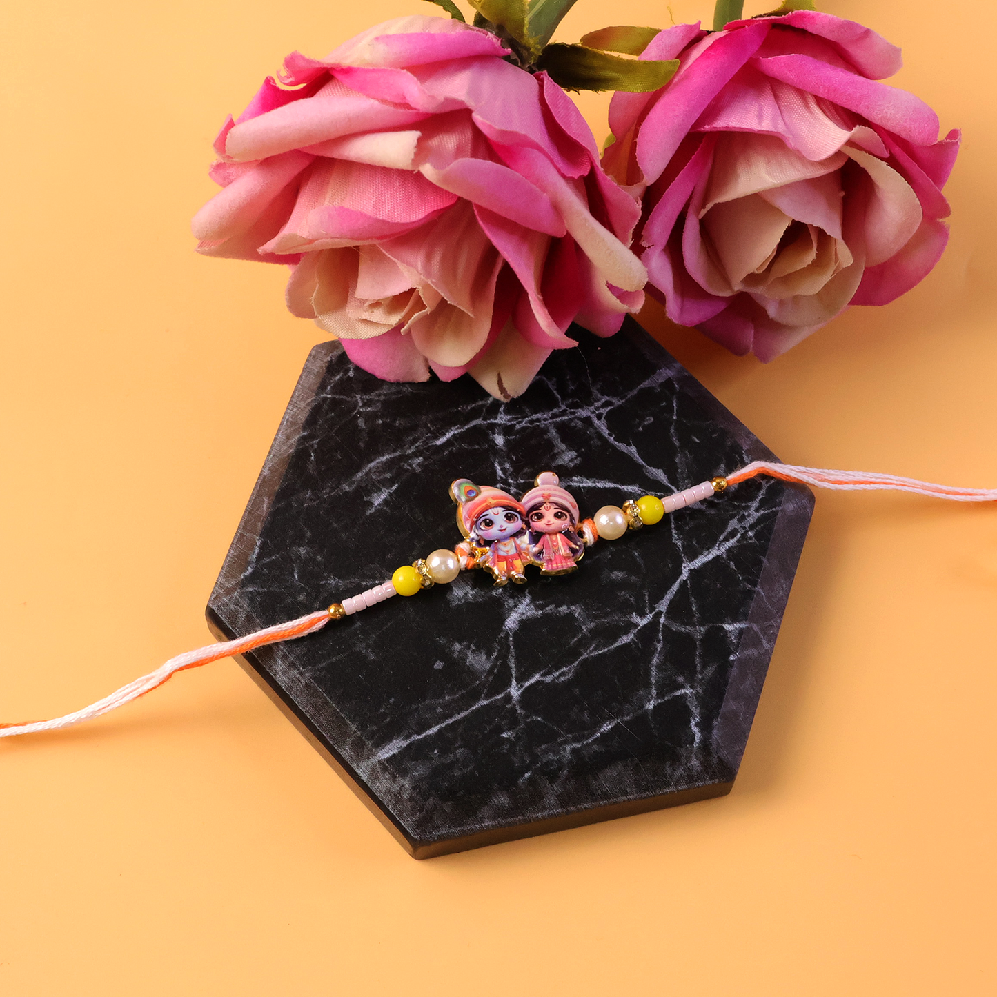 Traditional Krishna Radha themed Rakhi with detailing.