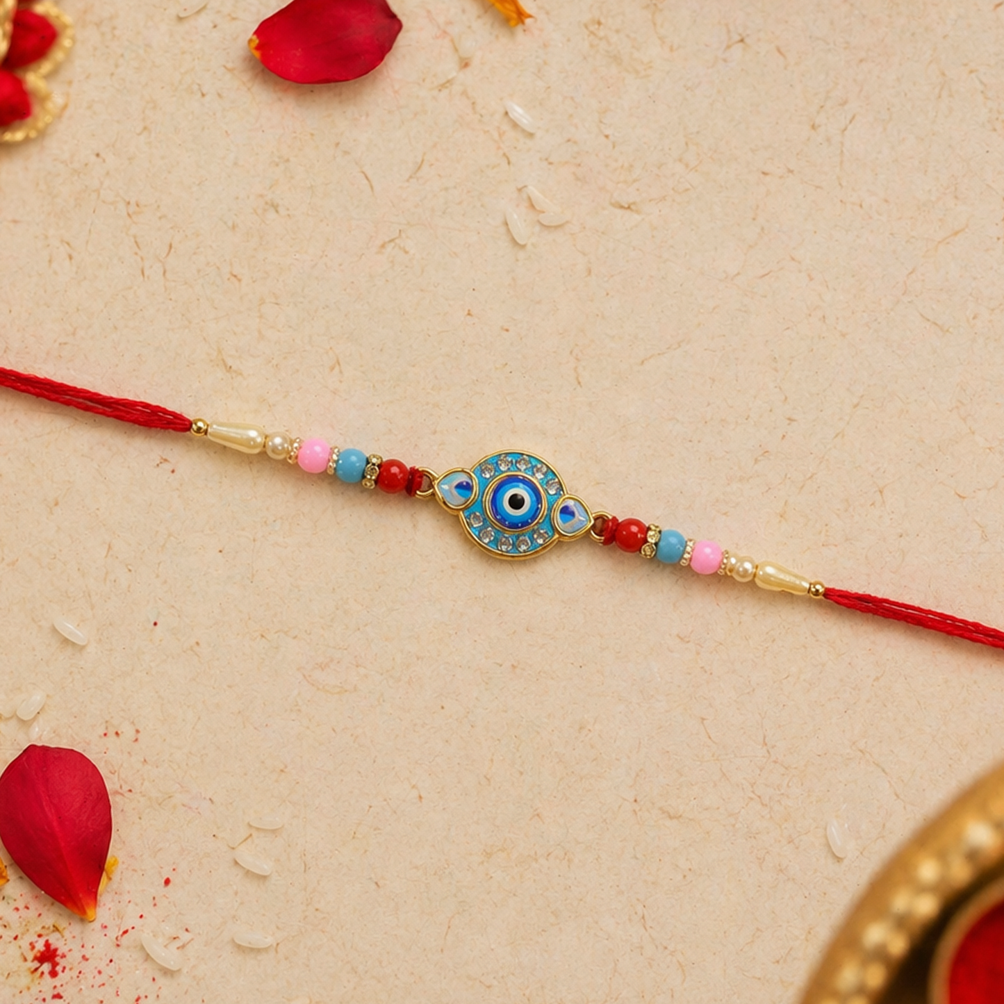 Detailed view of the central Evil Eye charm on the designer Rakhi.