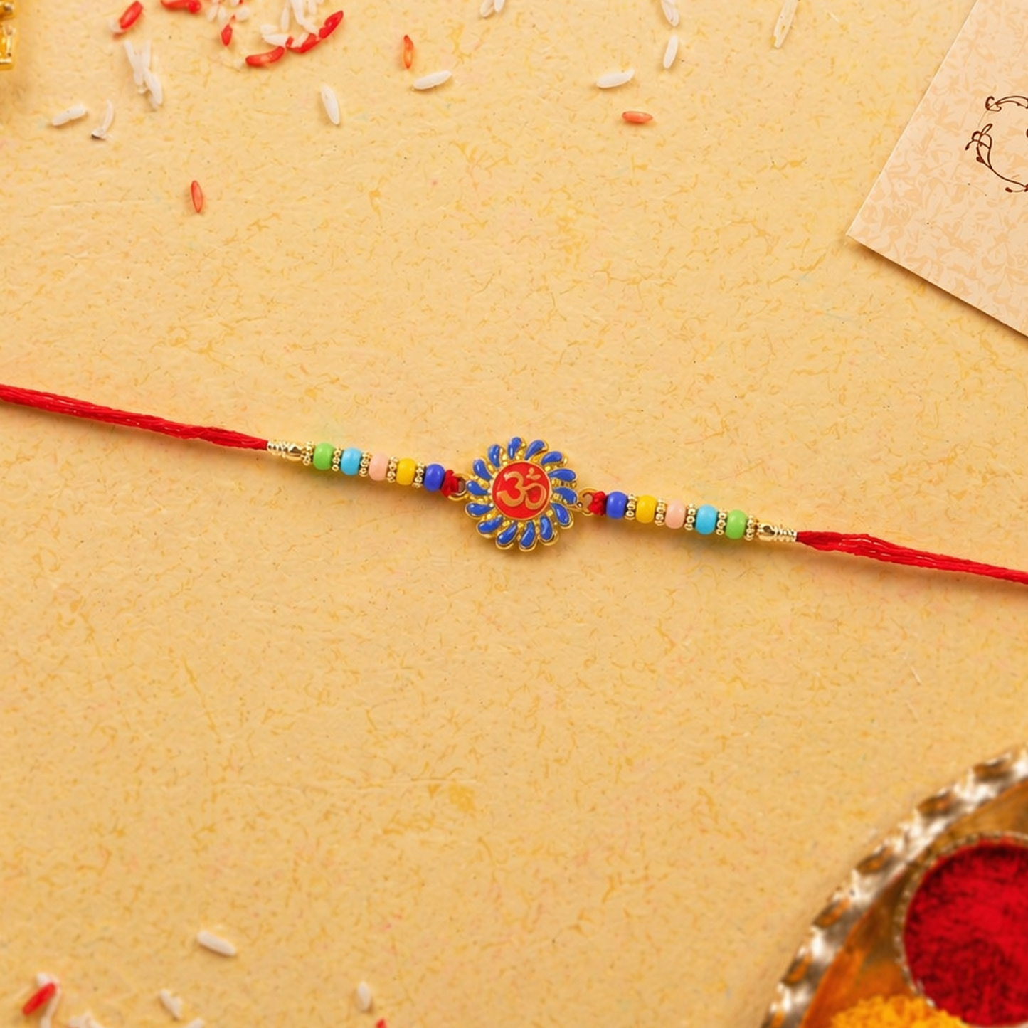 Detailed view of the soft thread and multicolor beads on Om Rakhi.