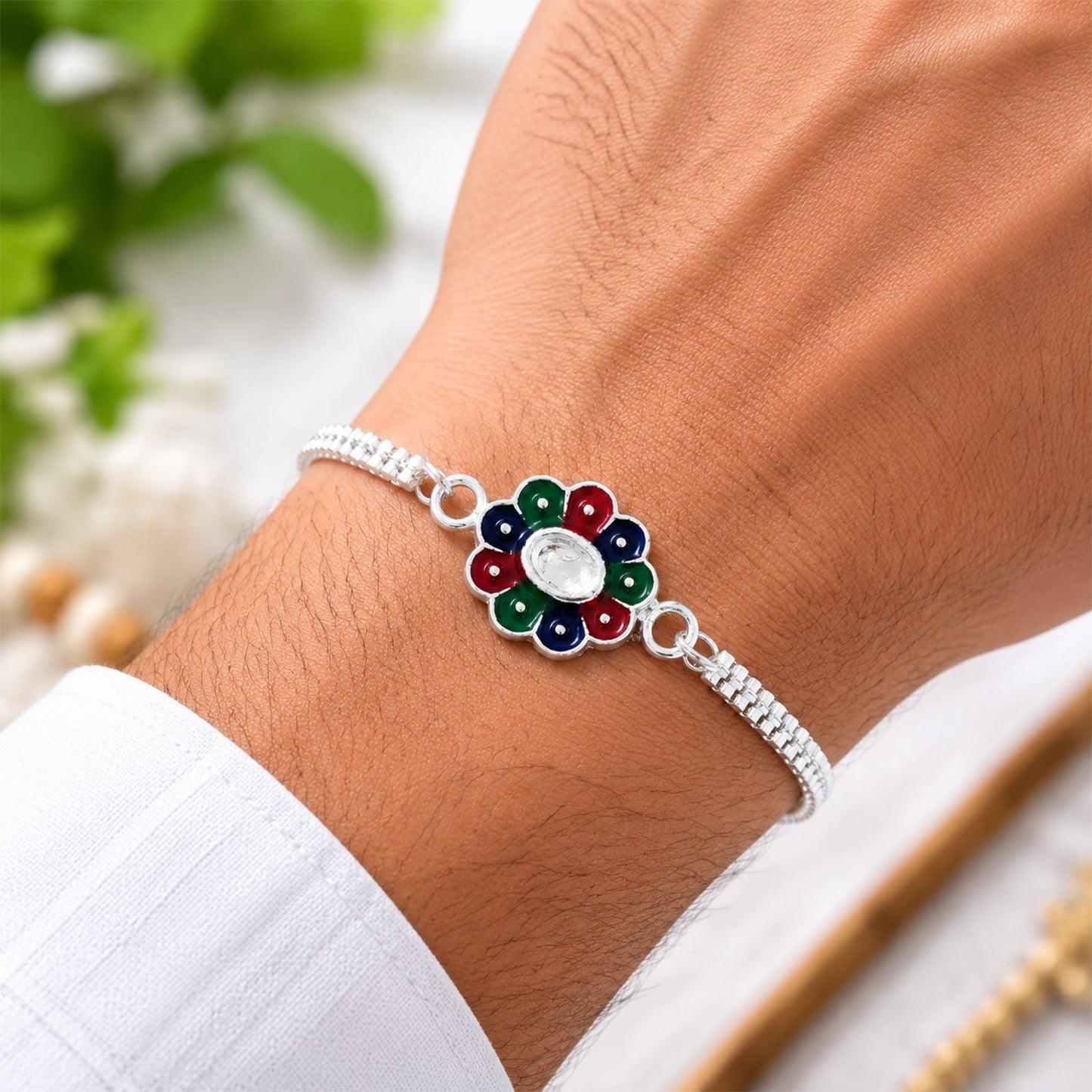 Close-up of colorful petal design on silver chain Rakhi for brothers