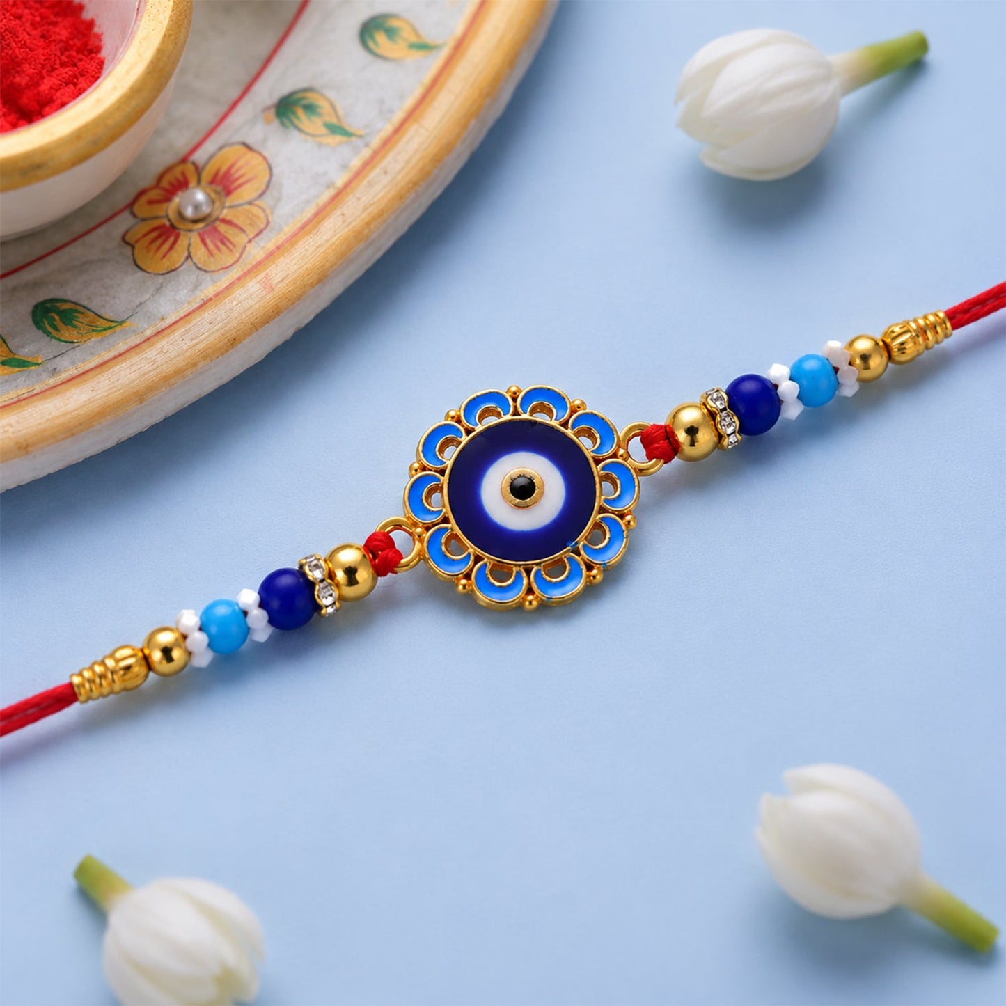 An Evil Eye Rakhi beautifully tied on a brother's wrist during the Raksha Bandhan celebration.