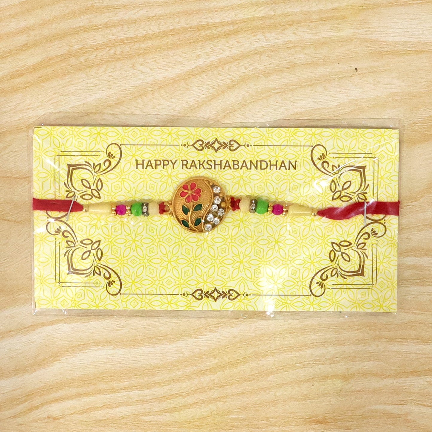 Handcrafted flower design Rakhi with red and green beads, symbolizing sibling bond