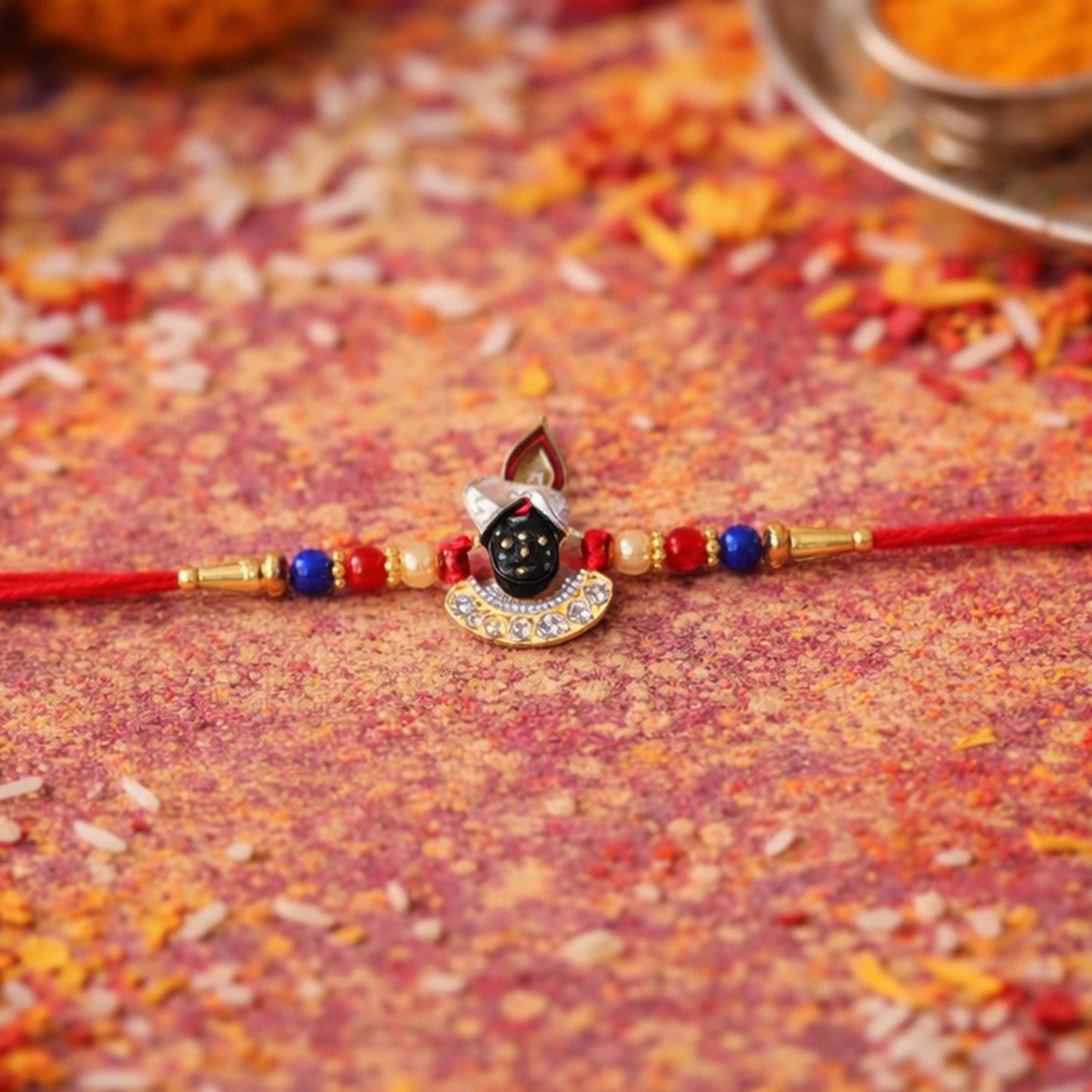 Elegant Krishna themed Rakhi featuring decorative beads