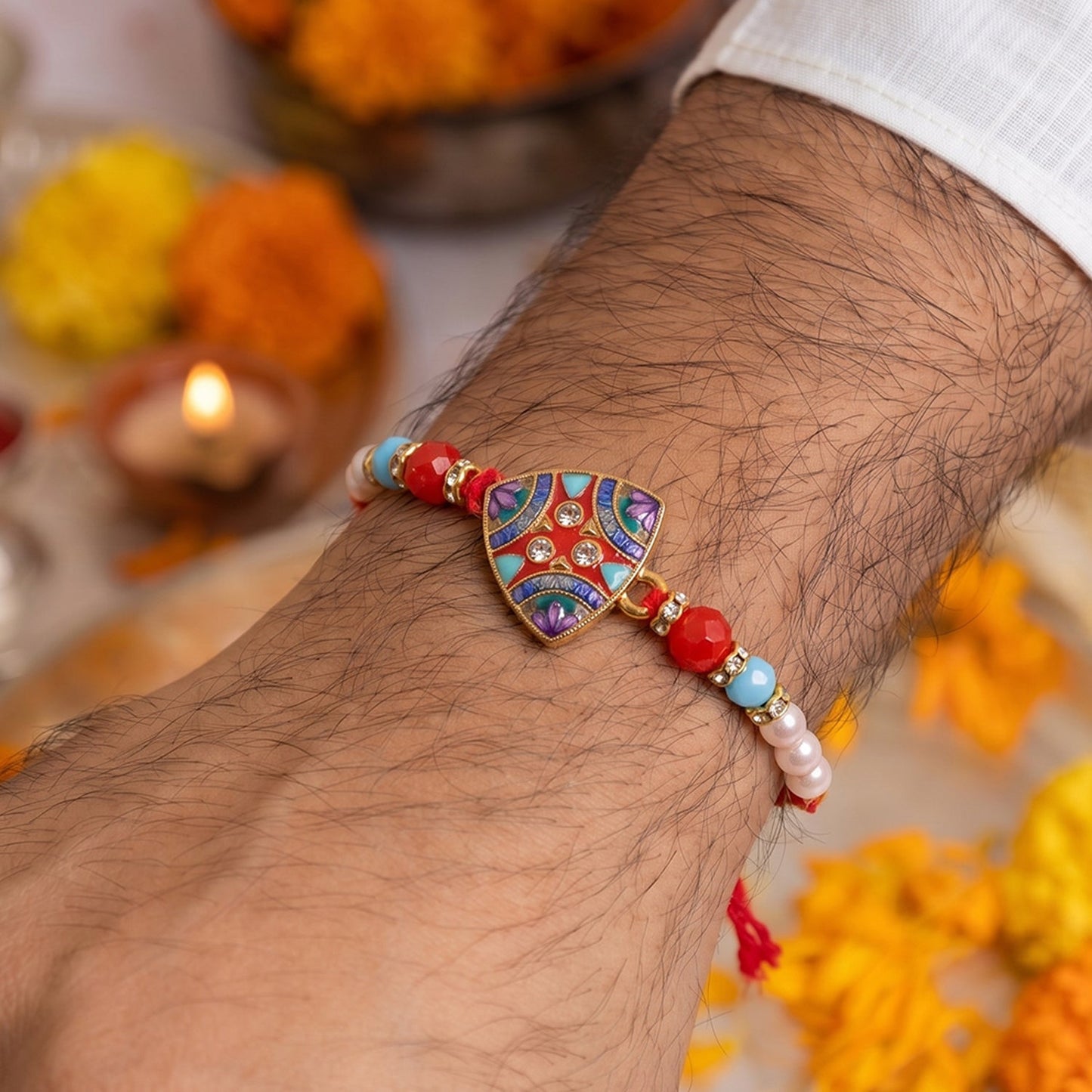 Close-up of decorative pearl beads and unique triangle centerpiece of Rakhi