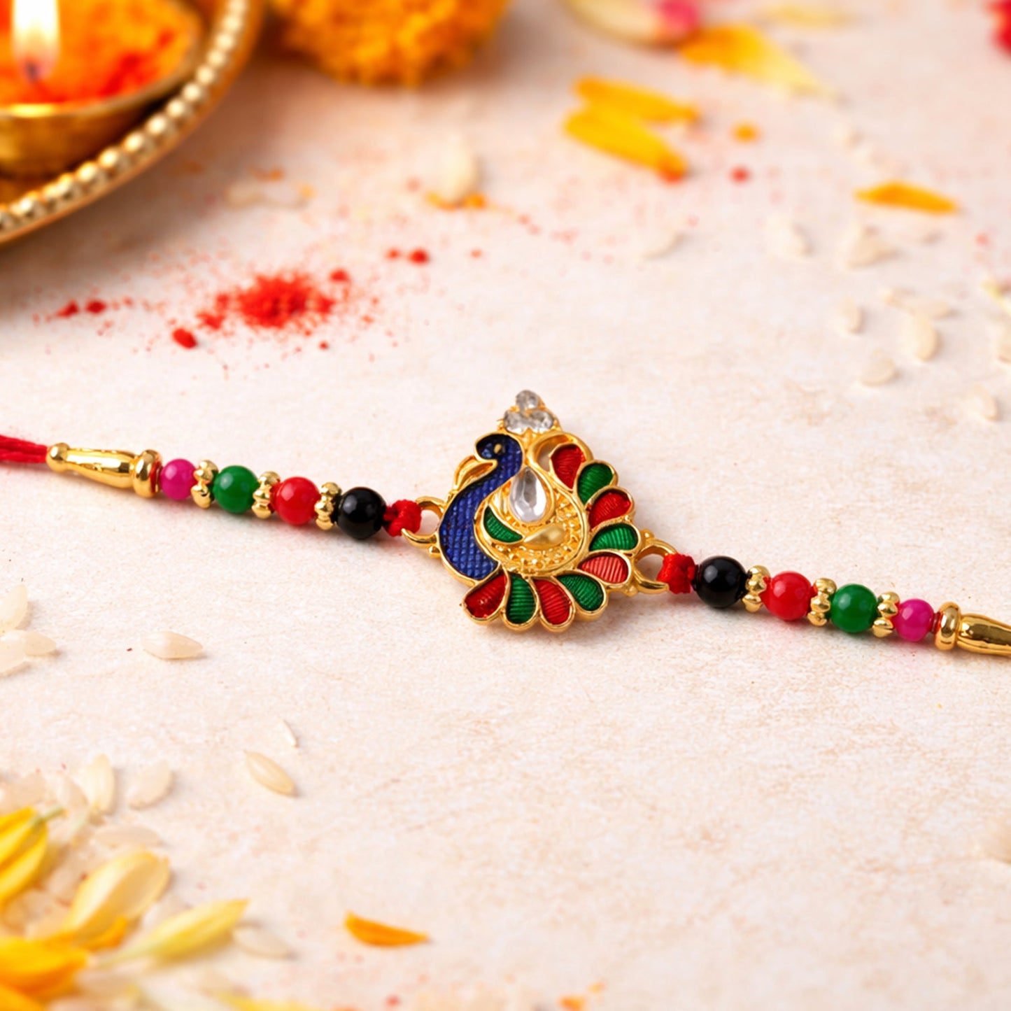 Close-up of artistic peacock centerpiece on rakhi